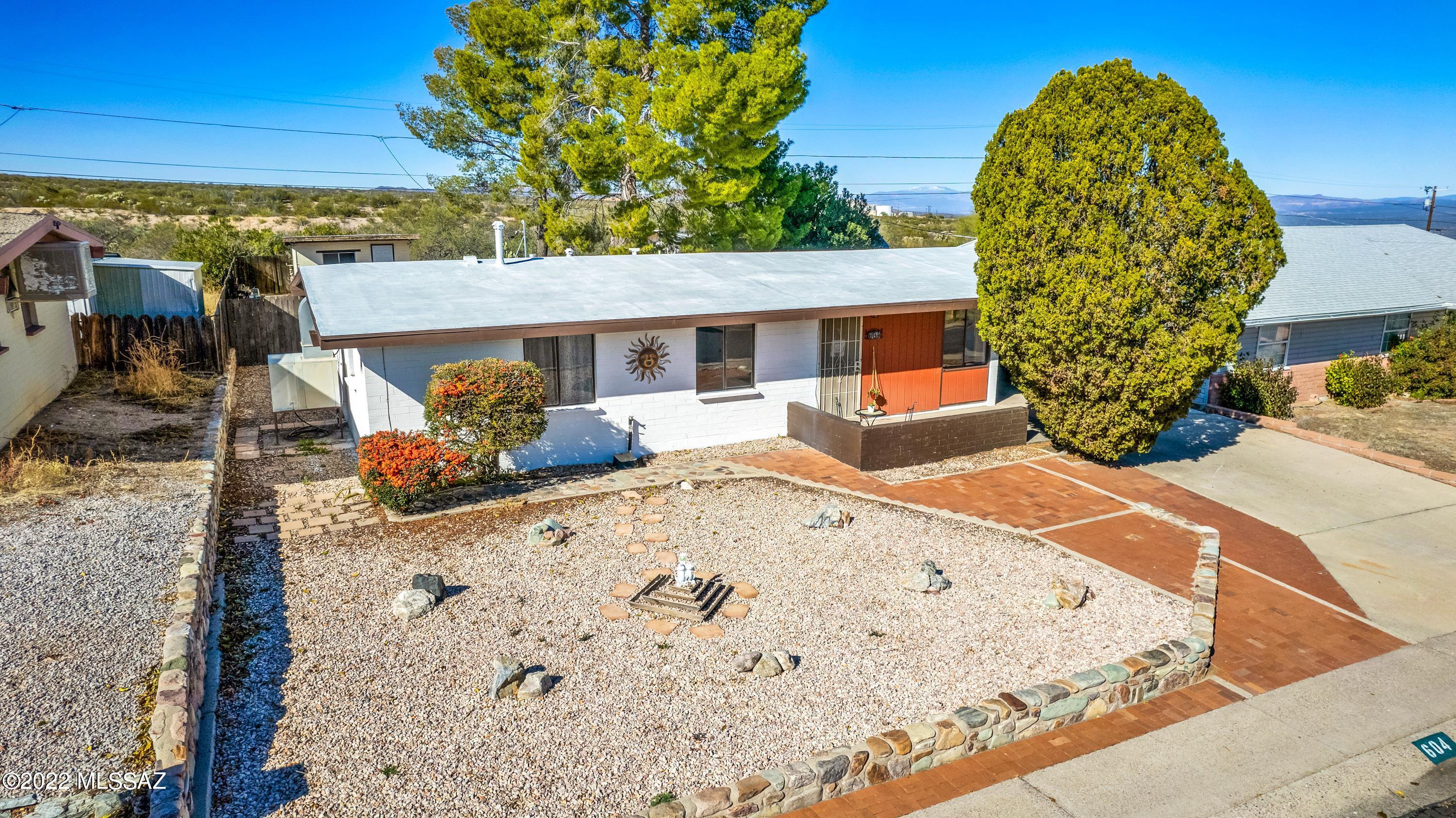 Fantastic 3 bedroom, 2 bath home with a great mountain view! Move in ready with brand new carpets, freshly painted and has an awesome sunroom! Bring your quads & toys and leave from your back yard to hundreds of miles of biking & hiking trails. You'll love the 2 detached storage sheds and workshop areas! Room to park your RV and grow your own garden. This home has stellar sunset views and  NO HOA fees! It has been professional cleaned and the roof has been re-coated for you!  Upgraded kitchen with pull out drawers and a lazy susan! Huge laundry room and bonus space off the primary bedroom.  What are you waiting for? Bring your family and add your own special touches and make this house your HOME today!