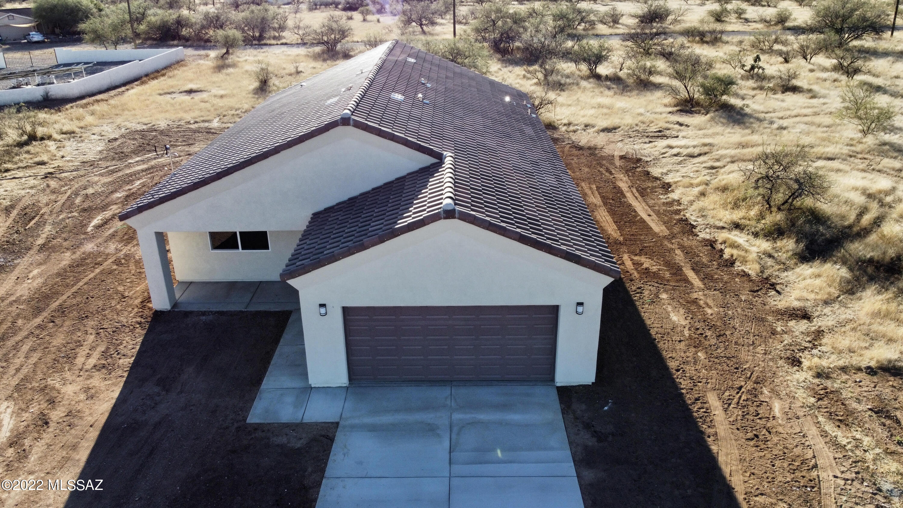 SELLER WILLING TO PAY UP TO $3K IN BUYERS CLOSING COSTS WITH FULL PRICE OFFER. Sewer connected, Liberty Water Company, Unisource Electric! Great mountain views, 2-year builder warranty from the date of completion with Certificate of Occupancy. Don't delay get your new Rio Rico home today! This home is fully completed with Granite countertops, Stainless steel appliances, Kitchen Island, Great Room, Dual paned windows, Covered back patio. Tile throughout! Extra large shower in primary bathroom and walk in closet in huge Primary bedroom. Mountain views from all the windows! Laundry room leads to the 2 car garage! 3 bedrooms 2 full baths! Driveway poured! All you have to do is move in! Rio Rico is a quiet beautiful area with cooler weather than Tucson! Seller will carry note too! Seller may add a fridge depending on offer price! Come see this new home today! If you want the driveway completed to the road seller is willing to extend it depending on the offer price.