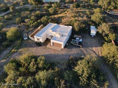 Gorgeous Santa Fe home on 1.25 Acres with some of the best views in cooler Oracle.  No HOA! This beautiful 3 bedroom 2 bath home has 9' ceilings, a beehive fireplace for those cool nights and a spacious master bedroom.   The heart of this open concept living space is the recently remodeled kitchen with it's copper accents.  Master bathroom and guest bathroom have also recently been remodeled.  This amazing lot has fruit trees, a circular drive and full RV hookups.  Come see what this great home and Oracle has to offer.   Call to schedule an appointment.