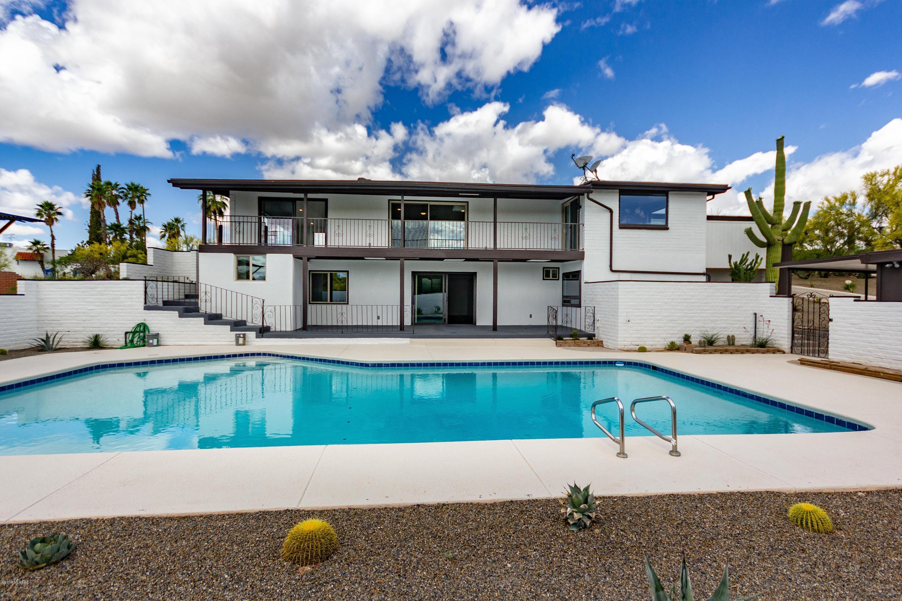 Gorgeous home nestled in desirable Foothills. 
This stunning 5 BR/6 BA home sits on a premium lot in natural desert with breathtaking mountain and city views. From the bright kitchen and living room to the huge backyard, there is plenty of space for a large family to enjoy; Freshly-painted interior and exterior,  kitchen has granite counter-tops and stainless steel appliances; wood-look tile throughout except for bedrooms, double pane windows and 4 new sliding glass doors, recently-installed A/C and pool system, re-plastered shimmering pool, luxurious bathrooms with lighted mirrors, two-car garage with storage, elegant ceiling fans; total of 3 fireplaces, roof has been coated recently, asphalt pavement on U-shaped driveway and concrete sideways all the way to the workshop. The detached 16'x32' finished workshop has been redone. There are many more indoor and outdoor features for this fabulous home. Must see to appreciated it!