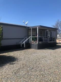 Nice 3 Bedroom 2 Bath home on 1.23 acre lot that backs  to natural desert. This move in ready manufactured home two large patio that features a large living room and eat in kitchen, separate laundry room. Two of the bedrooms have walk in closet and the master suite has it's own shower and garden tub. In the back of the MFH there are 2 large storage sheds which will stay. There is a separate manufactured home hook up to the west of the property. Don't let this one get away.There is an additional 1.23 acre lot adjacent to the property that is also for sale at this time.