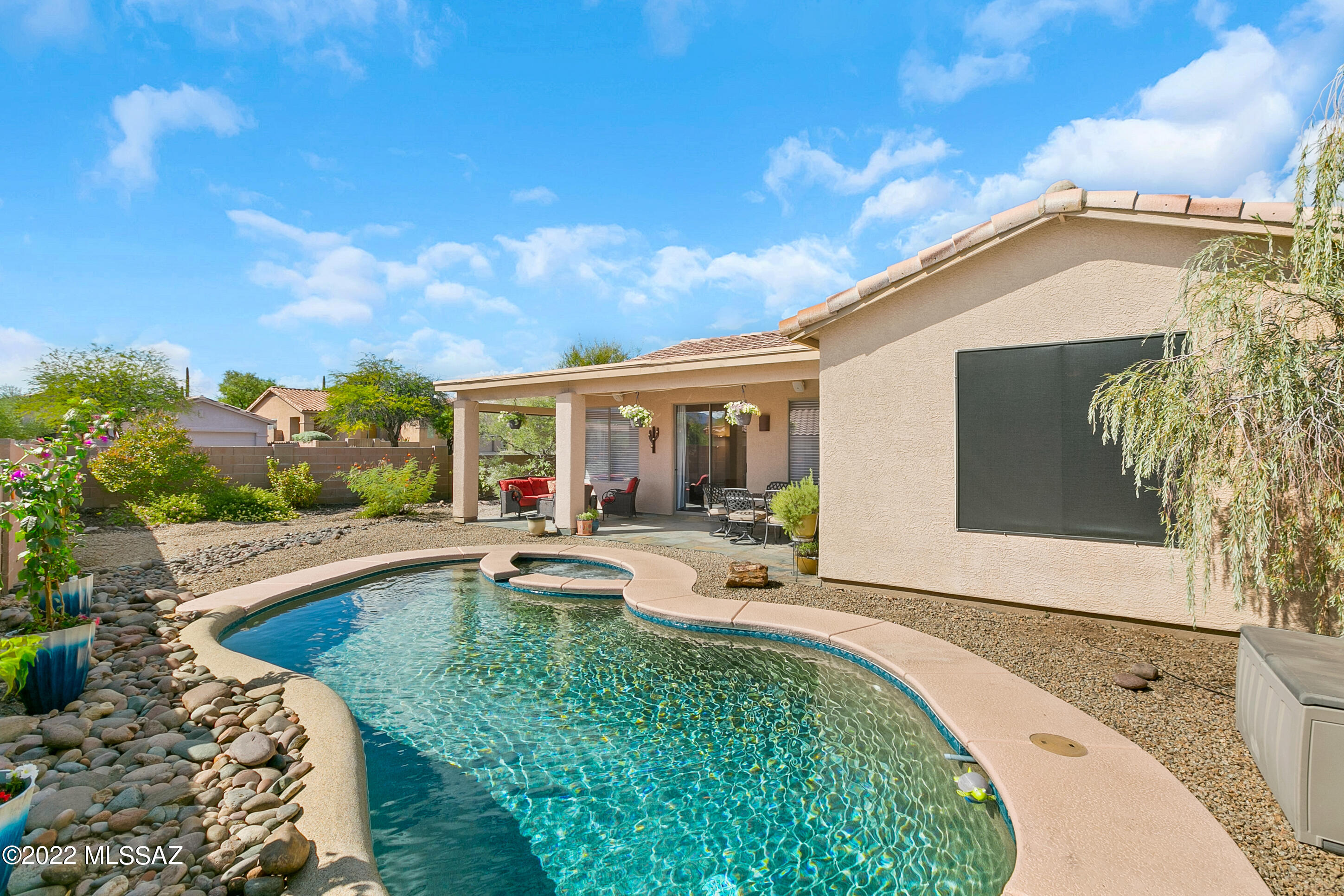 Don't miss this meticulously maintained home in desirable Rancho Agua Dulce. Features include spacious great room with high ceilings. Primary bedroom just off the patio with views of the backyard and mountains.  Tile surround in primary bath with walk in shower.  Newly installed commercial grade laminate floors. Large living area, kitchen with quartz counters.  Split floor plan,ceiling fans in all rooms,separate laundry room. Over sized 2.5 car garage adds lots of extra room for storage.  Gorgeous  backyard pebble tech pool & spa, fully extended covered patio with slate tile and great mountain views! Lovely gated community with pool and play park.
Close to shopping, golf, hiking and the University of Arizona.