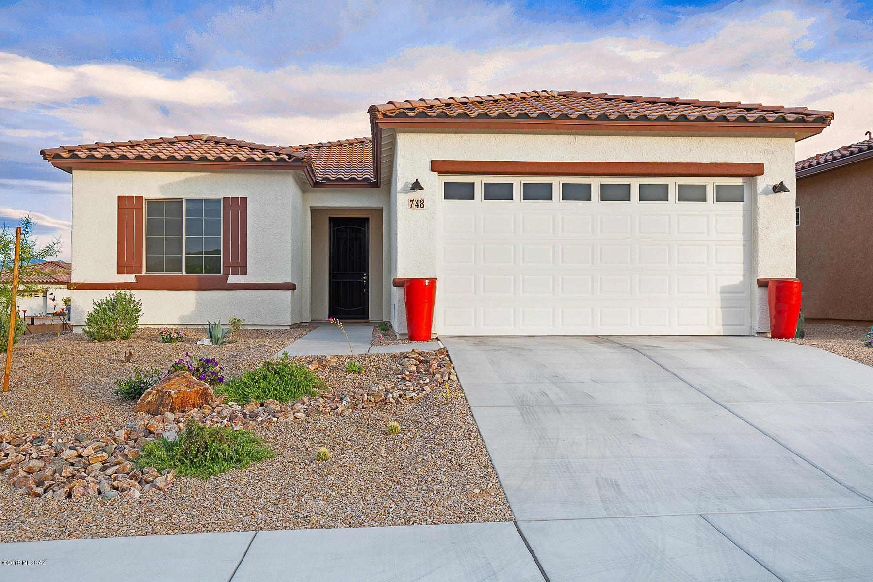 Why wait 7-8 months to build a brand new dream home when its right here in the heart of Green Valley? The Dorn-built Catalina floor plan has countless upgrades! Lets start w/ the modern tile backsplash that adorns the upgraded cabinets, granite C-tops and heavy duty pull out shelves.  Diagonal laid tile in all the right places, dual vanity sinks in the Master suite with a Bay Window, a custom C-fan in Great Room & a custom chandelier in dining area.  The patio is an entertainers dream w/ recently sealed pavers, roll down shade for privacy and a pergola for an intimate ambience that also helps with the morning sun.  Admire the beautiful colors dancing across the Santa Ritas every night & a simple glance to the North will make magical evenings with all the twinkling lights. Exquisite home!