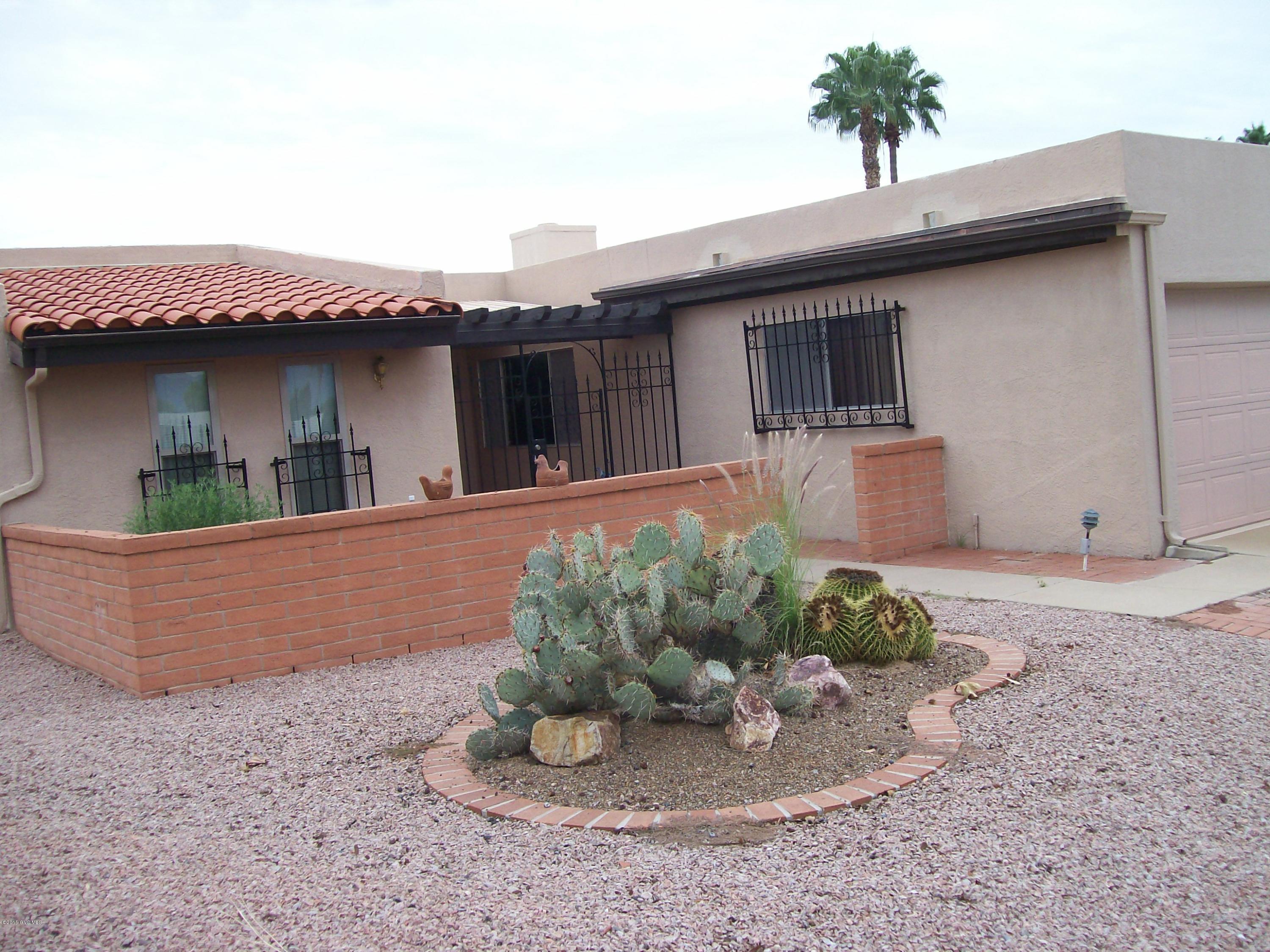 Enjoy sitting on your front patio with fabulous Mountain Views. The backyard is like being at a Resort with it's own Pool overlooking the golf course! This 2BR/2BA Townhome & 2 Car Garage is in move in condition. Cabinets in kitchen have been refaced, beehive fireplace, newer carpet, new windows in front bedroom. This is a must see! Refrigerator is in AS IS condition. NO GVR, but is available. SBOS for Most of the furniture. Clock, paintings, & personal items do not convey.