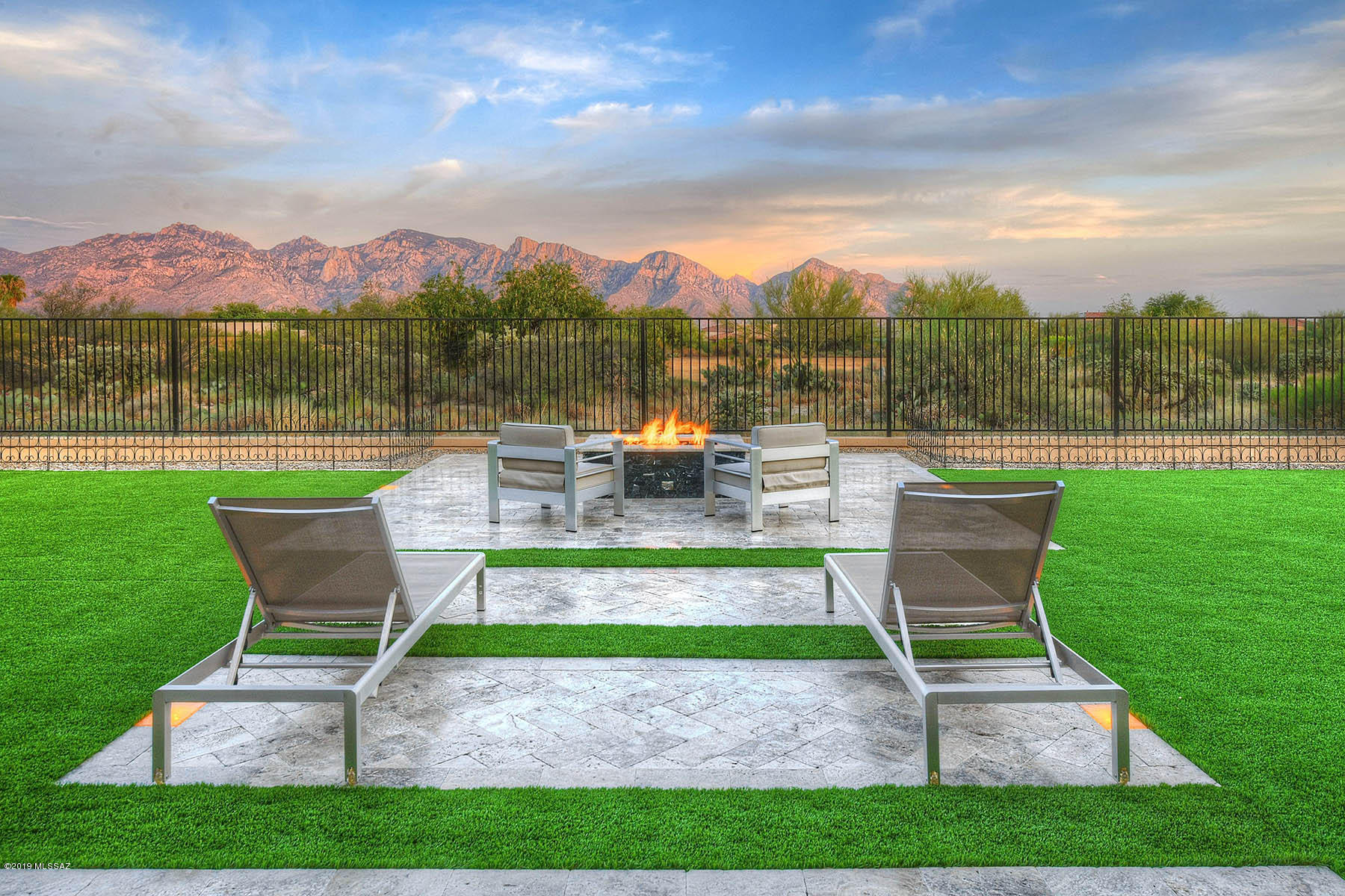 This 2017 Maracay build is truly exceptional in quality and finishes! Located in the heart of Oro Valley & close to amenities, yet tucked away in a quiet gated community on a .27 acre estate lot. This 4 bed/4 bath Pinnacle model boasts a grand paver driveway & entry into this spacious great room concept, perfect for entertaining. Formal dining room w/ coffered ceilings leads to the gourmet kitchen w/ SS appliances, granite countertops, subway tile backsplash, expansive kit island w/breakfast bar seating, walk-in pantry, & large eat-in dining area off the kitchen. Separate master retreat invites w/ spa-like bath well appointed w/ custom walk-in tile shower, soaking tub, dual sink vanities w/ granite counter tops, tile backsplash, & dual walk-in closets. Sizable den/office & media room are additional living space options. Separate bedroom w/ en suite bath is perfect for guest quarters. Access the resort-like backyard through a 12' glass slider wall and enjoy the stunning indoor/outdoor living from the covered and extended tumbled travertine patios w/ custom lighting, gas fire pit w/ seating area, & engineered grass yard all overlooking stunning unobstructed views of the Catalina Mountains! Take advantage of the community amenities that include pool, spa, splash pad, bbq/picnic areas, grass field, & park. This truly exceptional home is a must see.