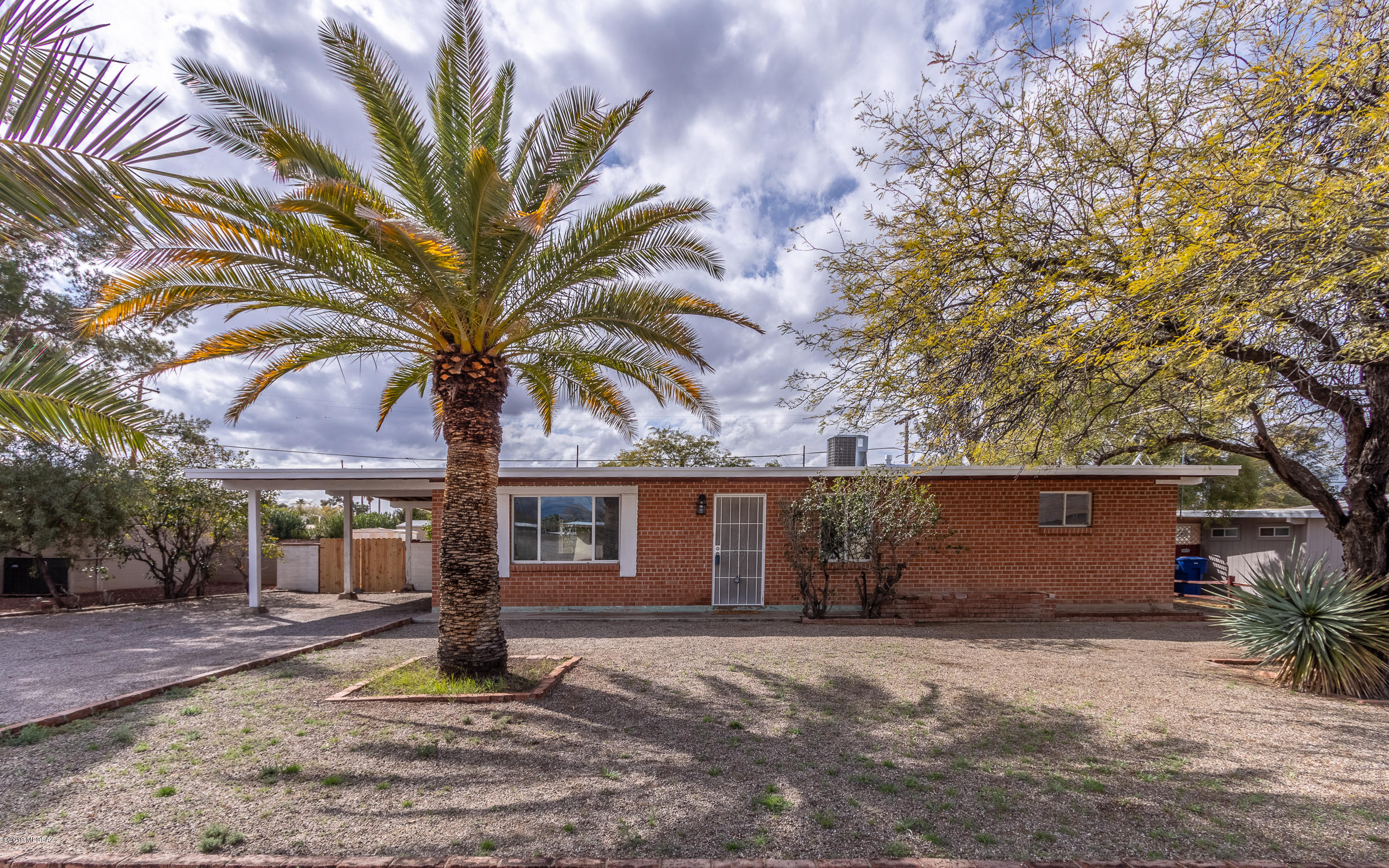 Come fall in love with this 3 bedroom, 2 bathroom Red Brick Home w/covered parking, a double-side gate, two storage sheds and a huge covered rear porch!  This home is tastefully updated without losing the 50's charm of a red brick home.  You are going to love this one for its huge private yard, surrounding block wall, NO HOA and NO CARPETING!!  This home has it all, including fresh, neutral paint, and plenty of storage with built-in bookshelves, built-in desk, hall and bathroom cabinets!  The roof has been coated and it has a brand new stove and hood vent.  The home has A/C and evaporative cooling!  The vanities, mirrors, lights, and toilets are new too!  All of this under $150k!  Schedule an appointment today!!