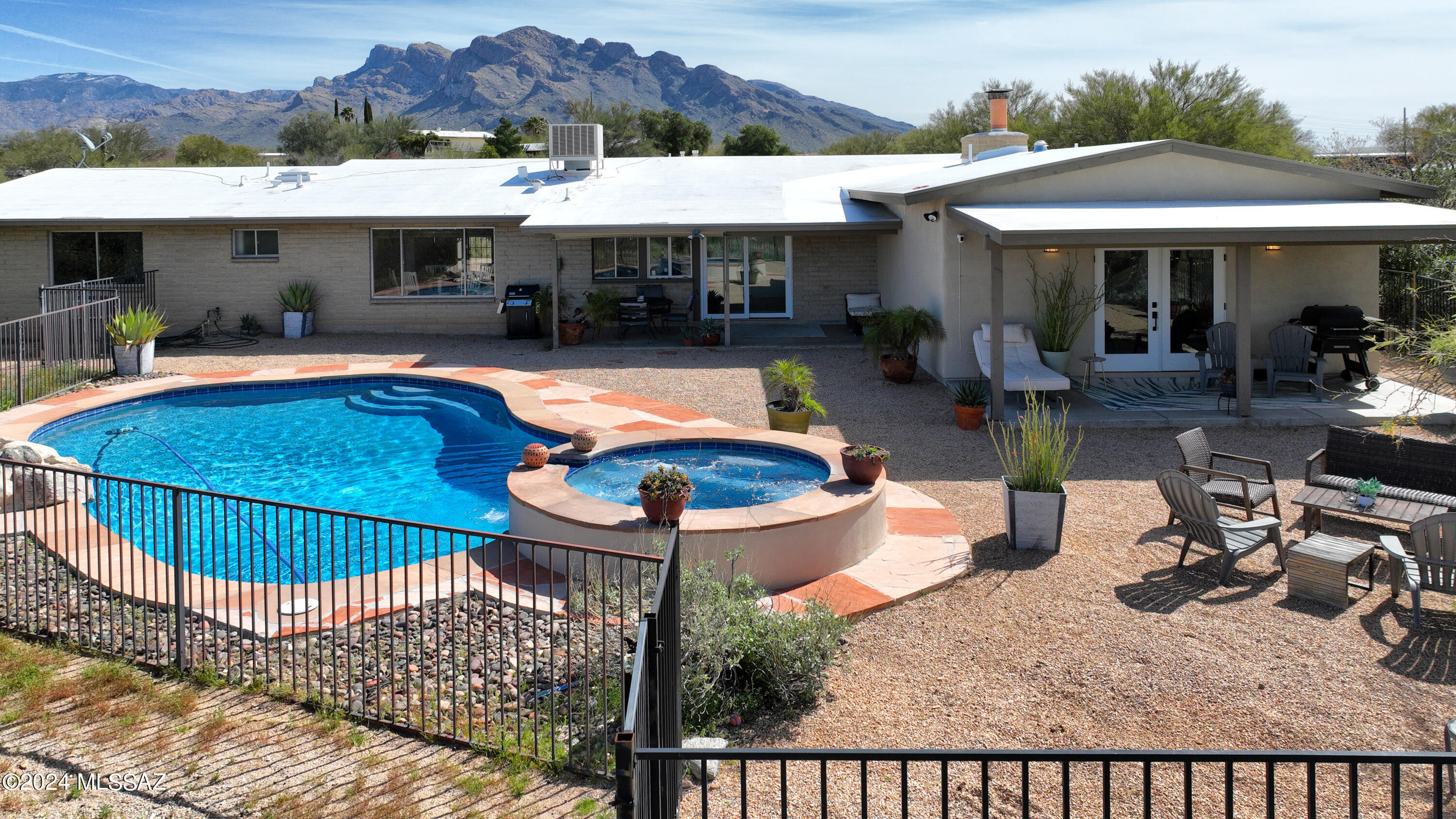This charming home nestled in Tucson's popular northwest side boasts stunning mountain and sunset views from it's wonderfully private 1.19 AC cul-de-sac lot.  Luxurious primary suite features ensuite bath w/dual sinks, walk-in shower, lg walk-in closet & French doors opening to the bkyd.   Entertain in the lovely kitchen featuring breakfast bar, granite counters,  SS appliances and opens to the adjacent family room with cozy fireplace and sliding glass doors that lead out to the beautiful backyard oasis with pool, spa and multiple covered patios..   Spacious living room offers stunning views of Pusch Ridge creating a beautiful backdrop.  Generous dining area off the living room ideal for gatherings w/family & friends.   2-car garage & ample storage round out this terrific versatile home.