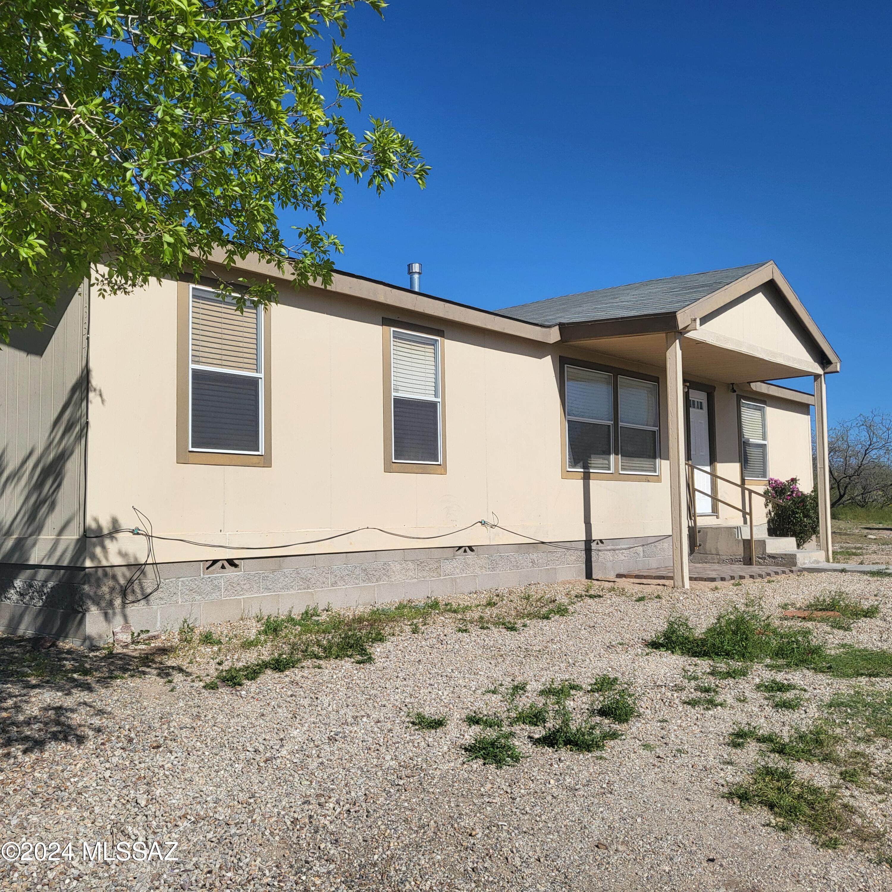 Just over an acre, with a little TLC, this can be a great home!  Vail school district, fenced back yard, mature trees.  Great potential awaits.
(Storage Shed is NOT included, to be removed prior to closing)
