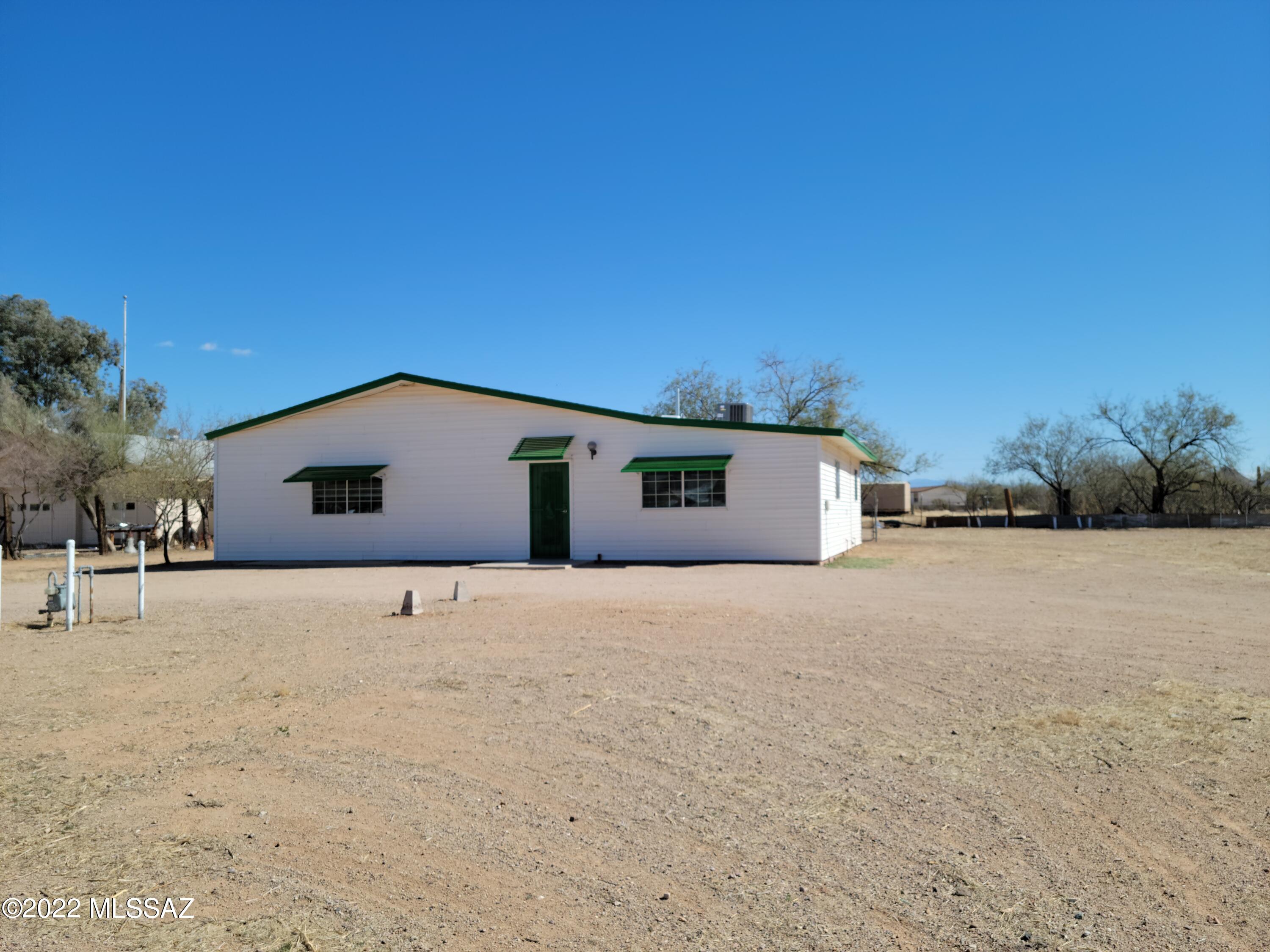 2 bedroom 1 bath huge family area and huge kitchen. Newer kitchen cupboards. Tile floors throughout. Large bathroom with skylight. New central AC. Over an acre in quiet area. Enclosed carport for 2 cars and enclosed storage room attached. Call Kat 520-245-4002