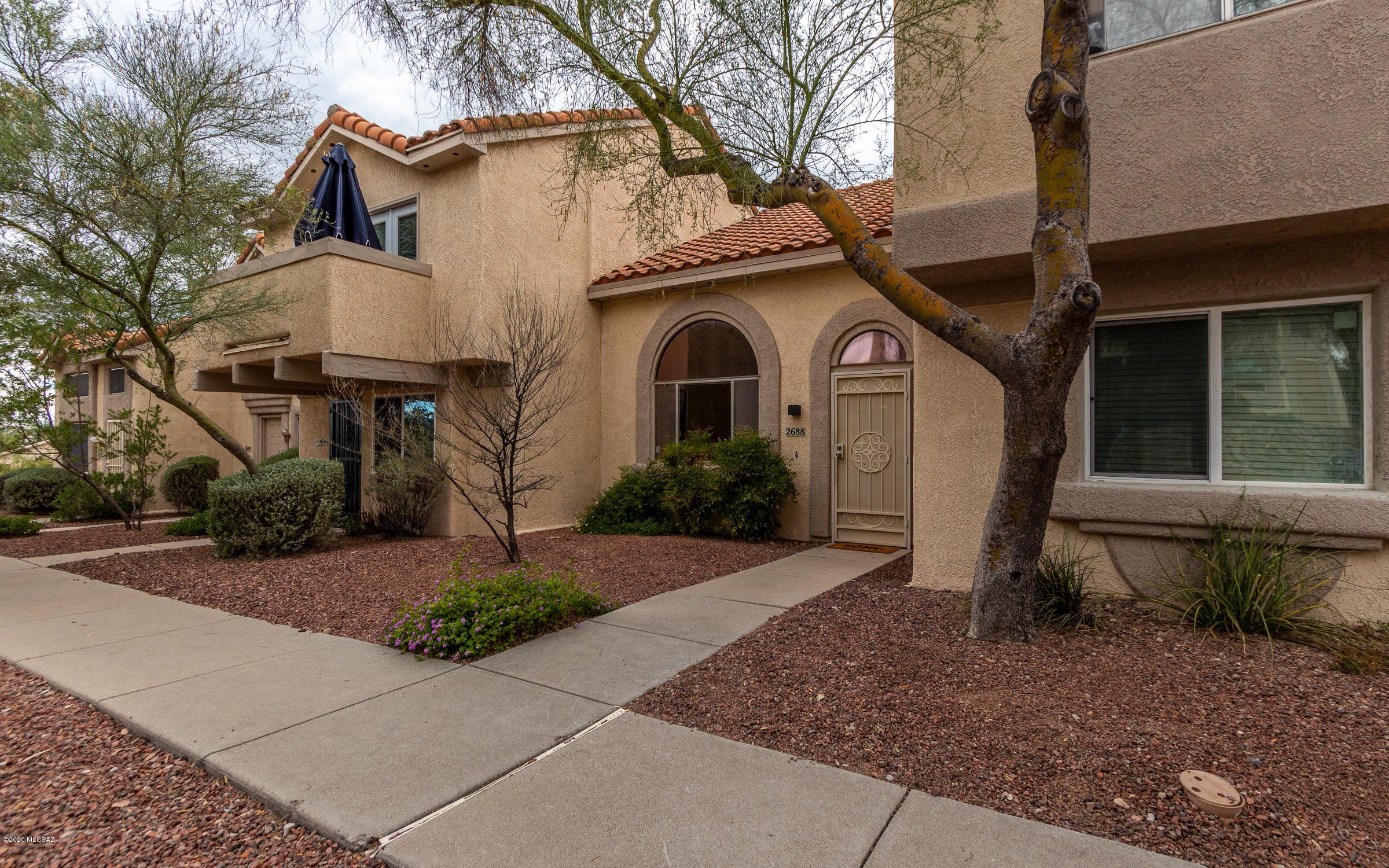 This beautifully remodeled townhome feels light, airy, and spacious. The newly remodeled kitchen has brand-new cabinetry, countertops, and stainless-steel appliances. The entire ground floor features new luxury vinyl plank floors. One bedroom is on the ground floor with a second bedroom upstairs. Poly pipes have been replaced. Both bathrooms have been remodeled. New carpet upstairs, fresh paint thru out. The back porch has a new roof. Close to Pima Community College West campus, St Mary's hospital, UA campus, shopping, and restaurants. It's located across from the community pool and close to walking trails. Don't miss this great home!