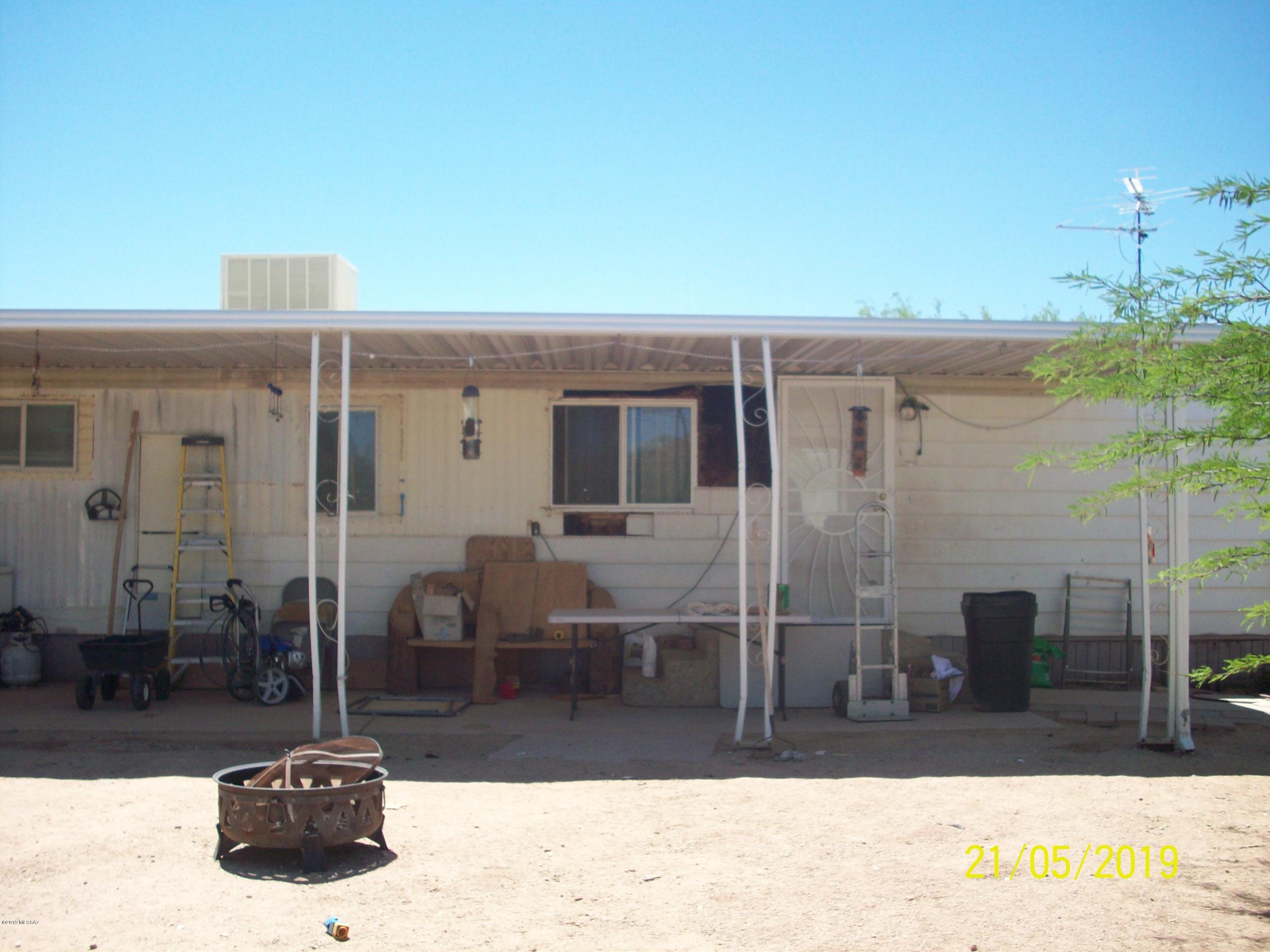 CASH ONLY. Needs a little TLC. 3 bedroom, 2 bath mobile home on a 1.33 acre lot. Newer metal roof, dog run, huge carport and work shed/shop. Close to Casino Del Sol. Newer stainless steel appliances and washer/dryer included.  Come see this little gem nestled at the end of a cul de sac.