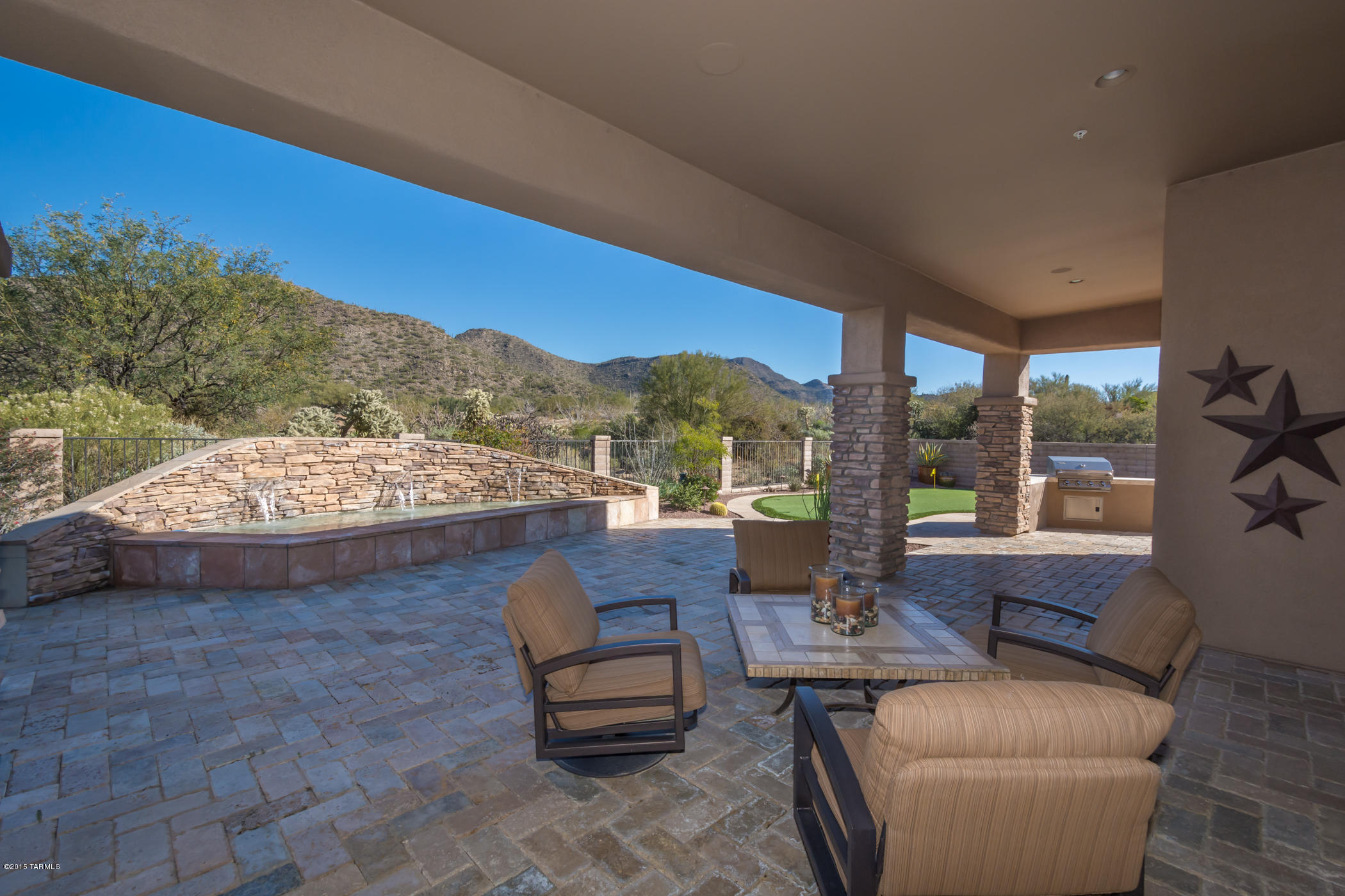 Semi–custom over ½ AC.3Bd/3.5 BA/Den PLUS Casita w/full BA. 3 car gar. 24X24 diagonal Travertine/Alder doors thruout.Enter DBL doors w/marble entry emblem. Kit. boasts cherry cabinets, granite counter & full bksplash, Décor SS appl, DBL oven, island, butler’s pantry w/office, breakfast dining area & breakfast bar. View GTRM offers dining area w/Tortolita MTN. views. Separate master suite w/dual sinks, jetted tub & walk-in shower. 2 large walk-in closets. Stunning powder room leads to remaining 2 bdrms w/their own closets & travertine/granite BA. Separate casita & full BA w/closet. Ext. landscape offers tumbled marble flooring. Covered view bkyd patio offers tumbled marble flooring & flagstone, flowing fountain, outdoor kit, chip & putt green, raised dining area. Shutters,Surr.sound,A