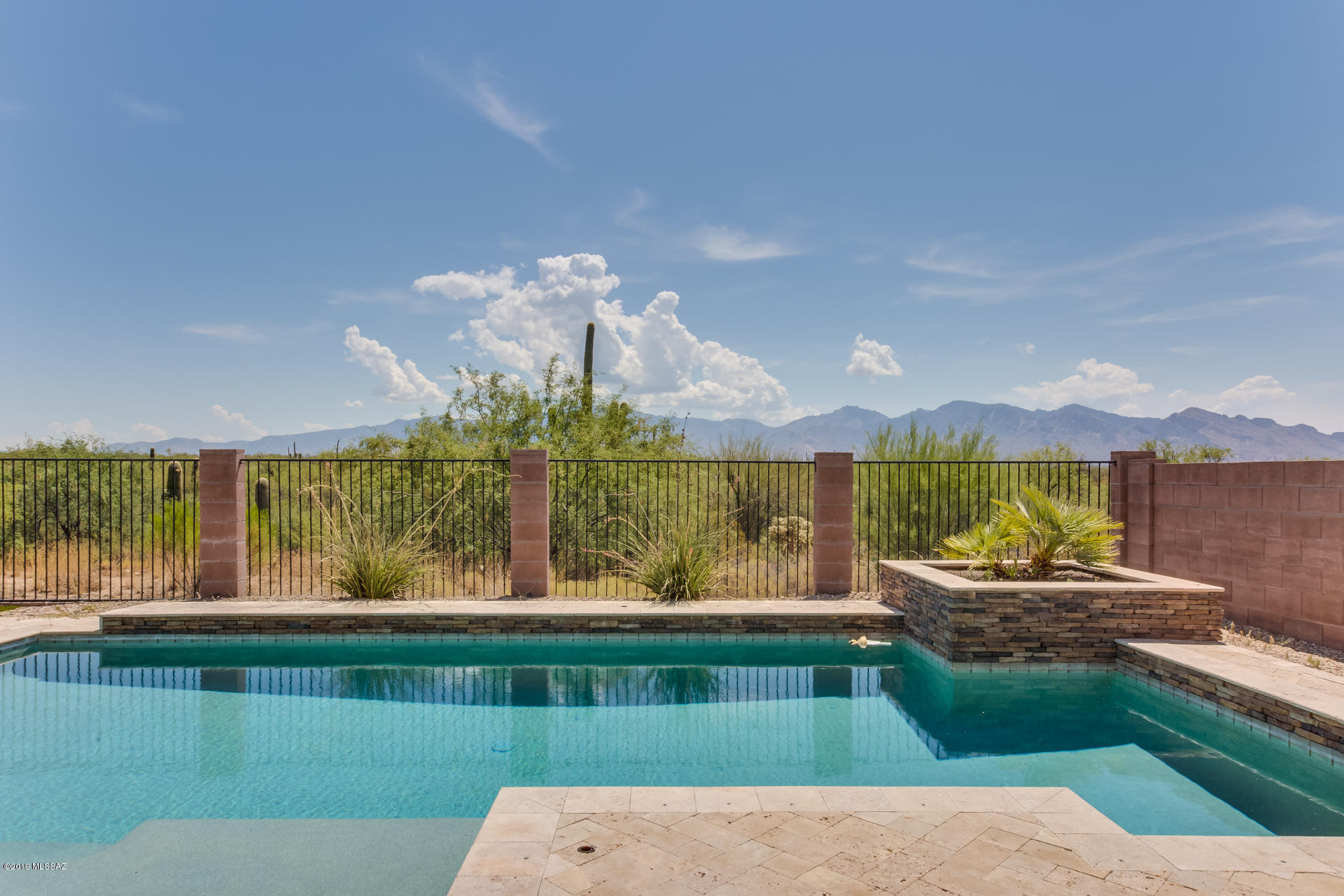 This home is a WOW! Spectacular 5BR/3BA/3 car garage (2,800 sq ft) Contemporary in gated Tangerine Crossing boasts unobstructed desert and Catalina views with no neighbors behind! Huge open-concept Great room w/view windows is ideal for entertaining with living/dining options plus gourmet chef's kitchen featuring SS appls and huge granite counter-tops & plenty of storage.  Office/5th bedroom plus full hall bath on main level. Upper level features an enclosed deck plus stunning Master Suite w/view windows, luxury bath and contemporary his/hers walk-in closet. Split bedroom plan with 3 added bedrooms and full hall bath. Outdoor living at its finest! Retreat to an outdoor oasis w/extended Travertine patio, sparkling oversize Pebble-tec pool, raised privacy wall and forever views! A must see!
