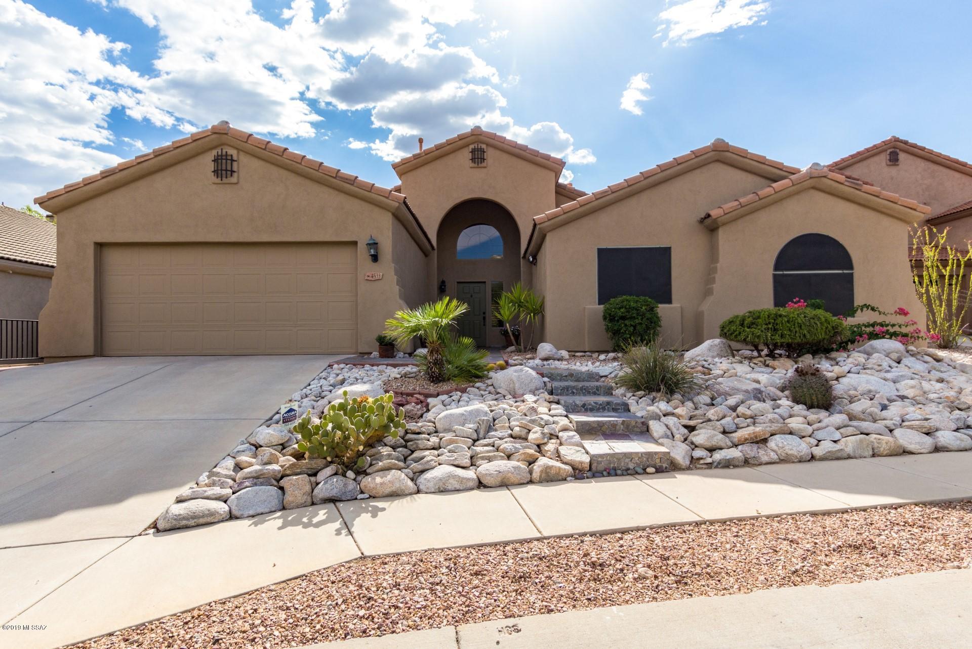 Stunning hill side lot nestled in the Sabino Mountain community with no neighbors front or back! This 4 bedroom 2 bath home welcomes you to soaring ceilings with mountain views from the formal living/dining room, the open space kitchen includes stylish glass backsplash with stainless steel appliances and a large island for additional prep space. The spacious great room includes a cozy gas fireplace and the master includes a sliding glass door leading out to the patio and full en-suite with separate shower and double sinks. Enjoy time in your private backyard with the large covered patio, even a water harvesting system and recently painted exterior. HOA includes community pool and spa, open enrollment District 16 and one mile from Sabino Canyon recreation area. Make this your forever home.