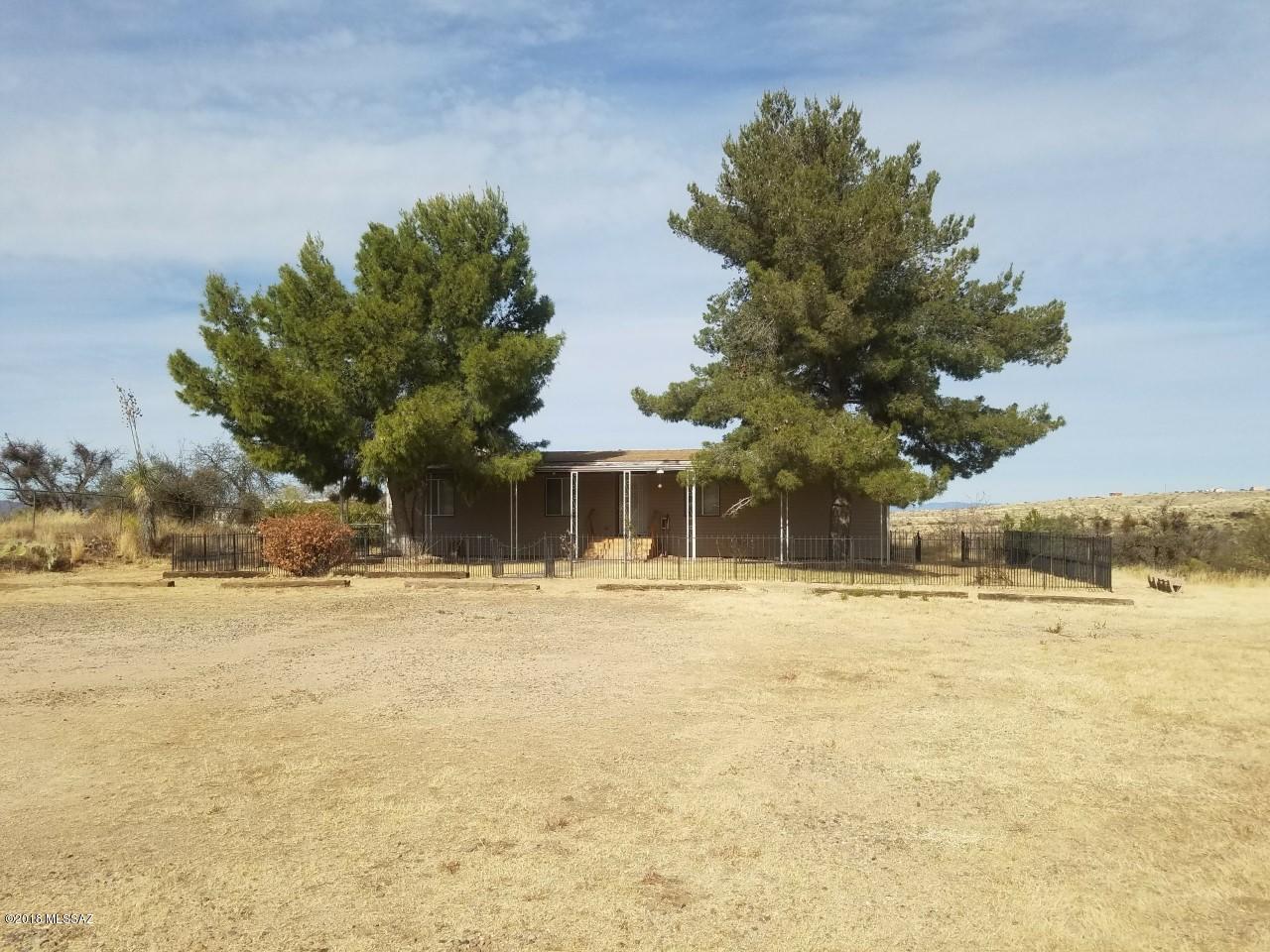 Redman dbl-wide MH on 1.33 fenced acres with 3 bdrm & 2 baths.  Nicely located with no homes to the north.  Electric entry gate for easy entry.  Split bdrm plan with carpet and vinyl flooring.  Solid wood front and rear steps with cvd front/rear patios.  Home needs some cosmetic repairs and sold AS IS.