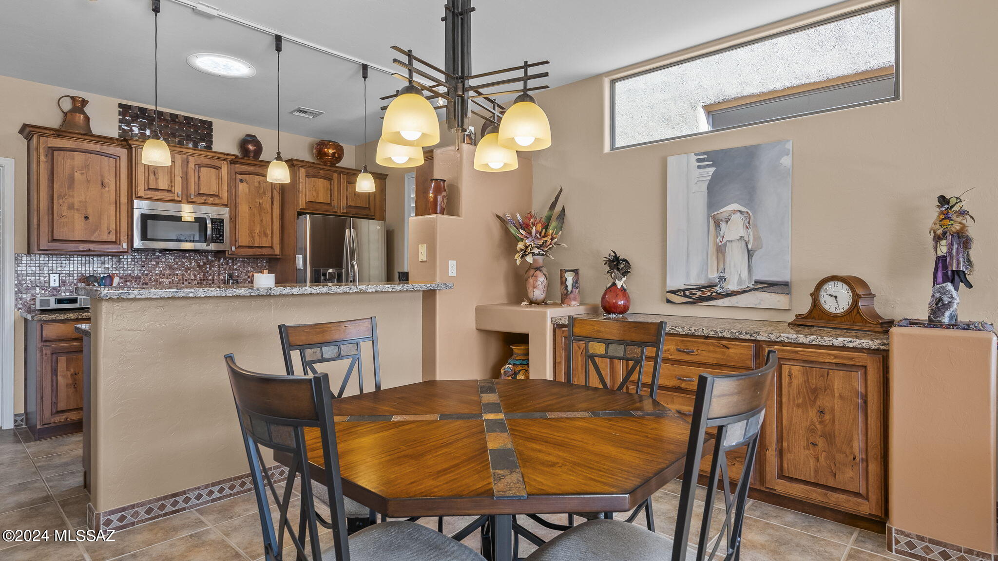 Come welcome yourself to this beautiful home located in The Springs at Santa Rita. Here you will have amazing views of the Santa Rita Mountains to enjoy.  The interior design and details in this home are endless, from the tile flooring, fireplace, granite countertops, pull out cabinet drawers, newer windows, just to mention a few plus all the mountain views you will defiantly feel all the comfort and luxury in  this home.  The Kitchen offers plenty of cabinet and counter space and has a breakfast bar as well as a dining area.  The appliances are all stainless.   There is a Primary suite with a nice walk-in closet and nicely sized bathroom with tiled shower.  The second bedroom offers an en suite bath with tub and shower.  Enjoy the convivence of an attached garage, as well as a water softener.  There is also a  Green Valley Recreation Center right there in The Spings, so walking distance you will have all the great amenities to enjoy.   Come and see this beautiful home in The Spings, enjoy the good life here.