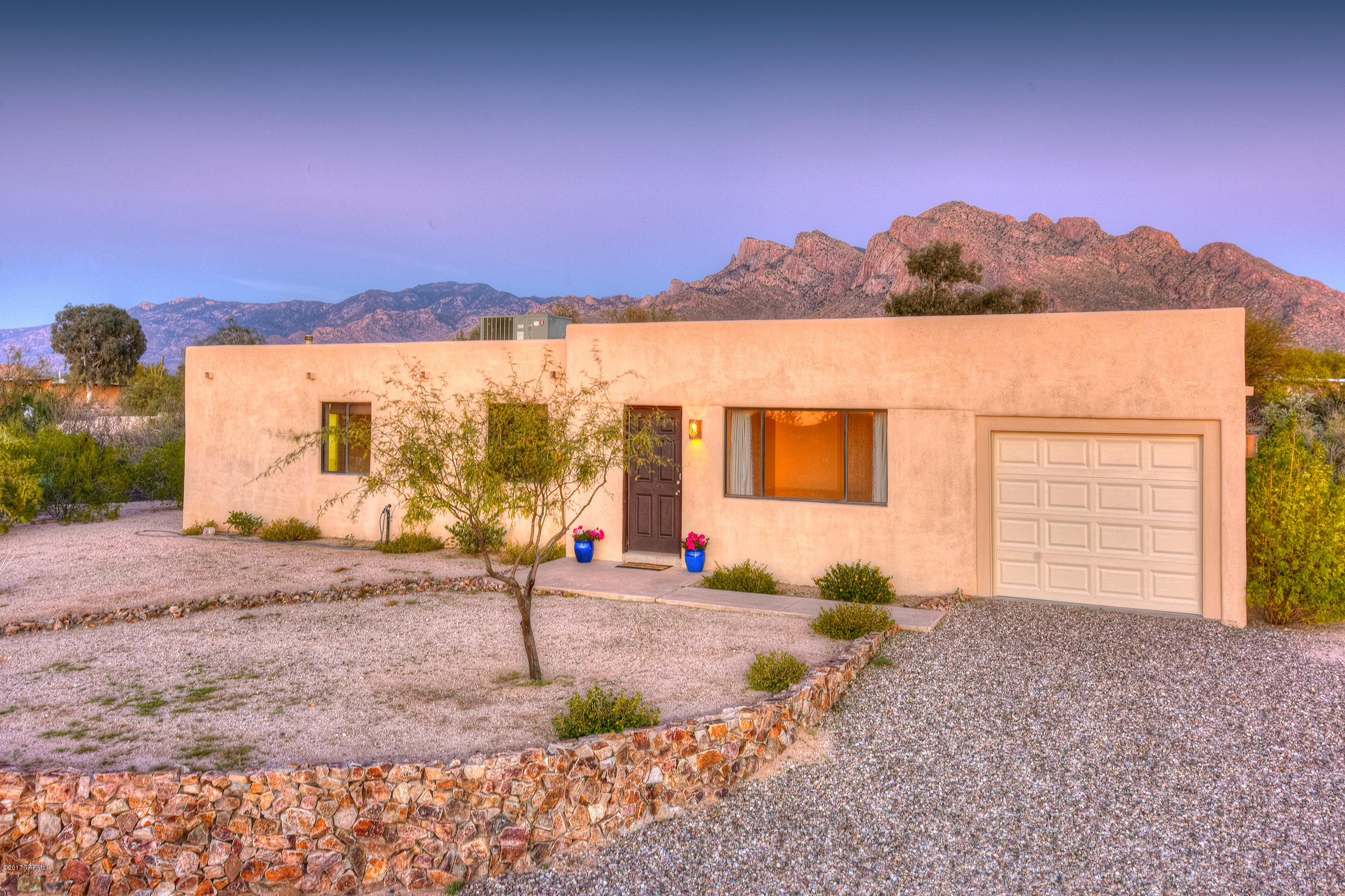 Amazing views of Pusch Ridge with a super private open natural desert yard on an oversized 1.7 hilltop acre lot.  Home is in great condition, move in ready with a very open floor plan.  Kitchen was updated with concrete countertops & LG stainless appliances.  Beautiful bamboo floors in the bedrooms.  Bathrooms are very modern with travertine floors and the master bath has a spacious walk in shower and separate tub.  NEW 2nd AC with split air handlers in kitchen and living spaces.  New main water valve, new water pressure regulator, new water heater, new garage door.  Location is prime NW situated conveniently to Oro Valley & Foothills shopping destinations.