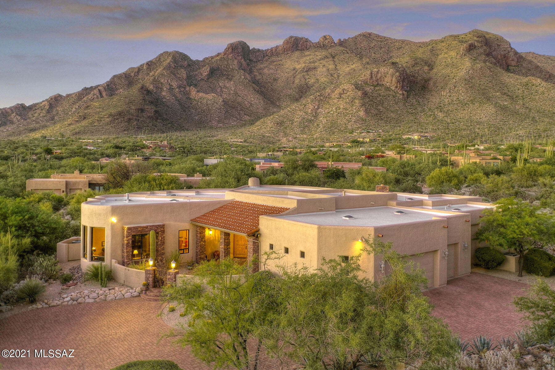 This delightful Southwest style home in prestigious Pima Canyon melds casual lifestyle, quality of construction and attention to detail sought by the most discerning buyers. Perfectly sited to capture the jaw-dropping beauty of the Catalina Mountains.   The great room is stunning with soaring wood beam ceilings, a cozy corner fireplace, built-in entertainment center and a wall of windows framing the mountains. The popular 5BR/4BA split floor plan offers privacy for all.  The abundant outdoor space with a built in BBQ, custom stone fireplace, lush desert landscaping is perfect for enjoying the Tucson lifestyle.   Don't miss the opportunity to be the second owner of this fabulous property.