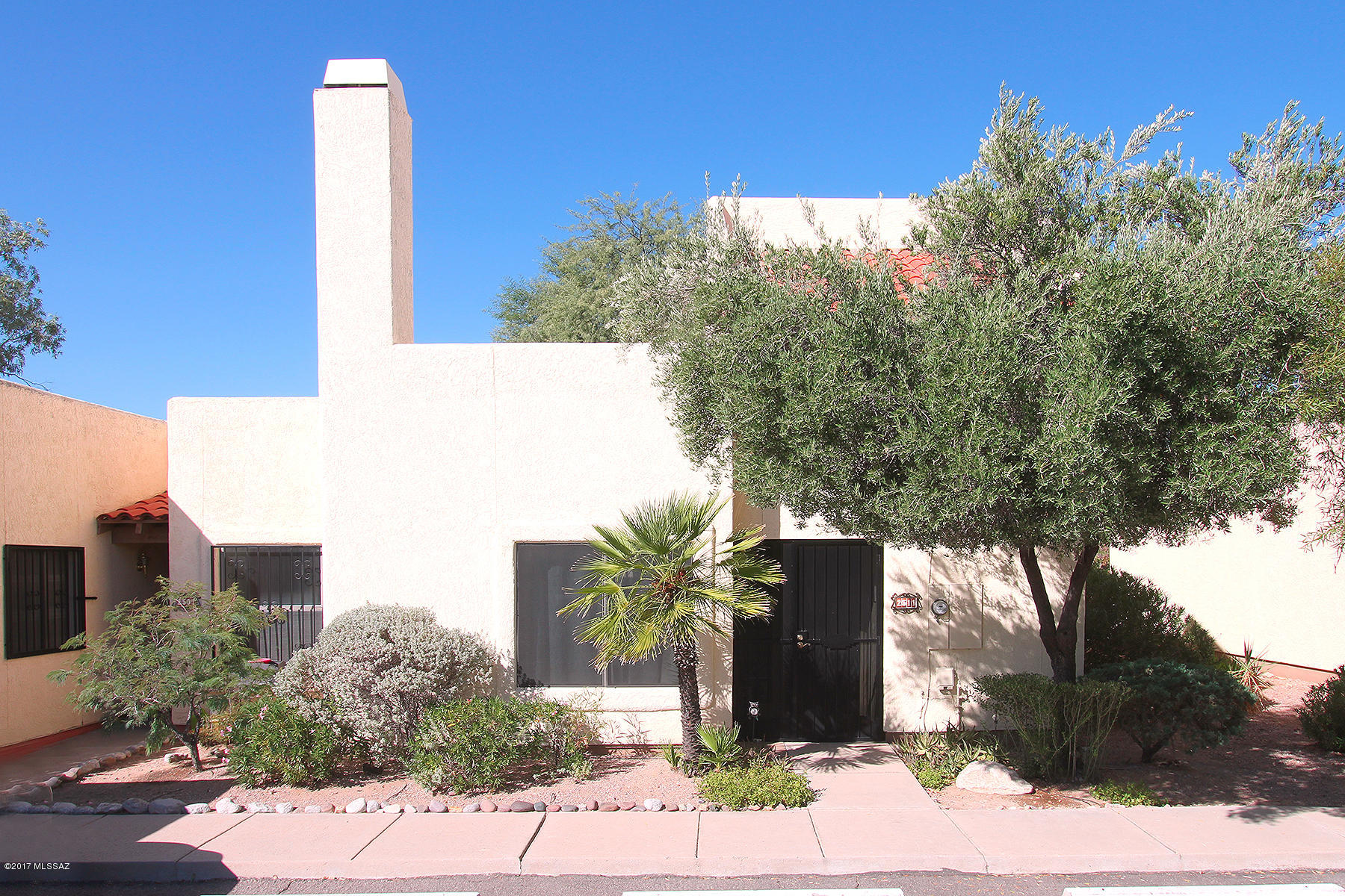 Open Sunday, October 29, 1 to 4. Enjoying the sunsets from the master bedroom private balcony, is just one of the amenities of this west side townhome in a gated community. This 3 bedroom/2 bath townhome offers lots of options with 2 bedrooms downstairs and only the master bedroom and bath upstairs. With an open floor plan, the third bedroom with French doors offers an option of an office or sitting room opening to the outside enclosed patio. With a vaulted ceiling in the living area is open and has a fireplace for a cozy atmosphere. New carpet for the guest bedroom, stairs and master bedroom was just added. Stainless steel appliances finish off the kitchen. The community has a swimming pool and spa. This community is located with an easy commute to Pima, UA and is on a bus route.
