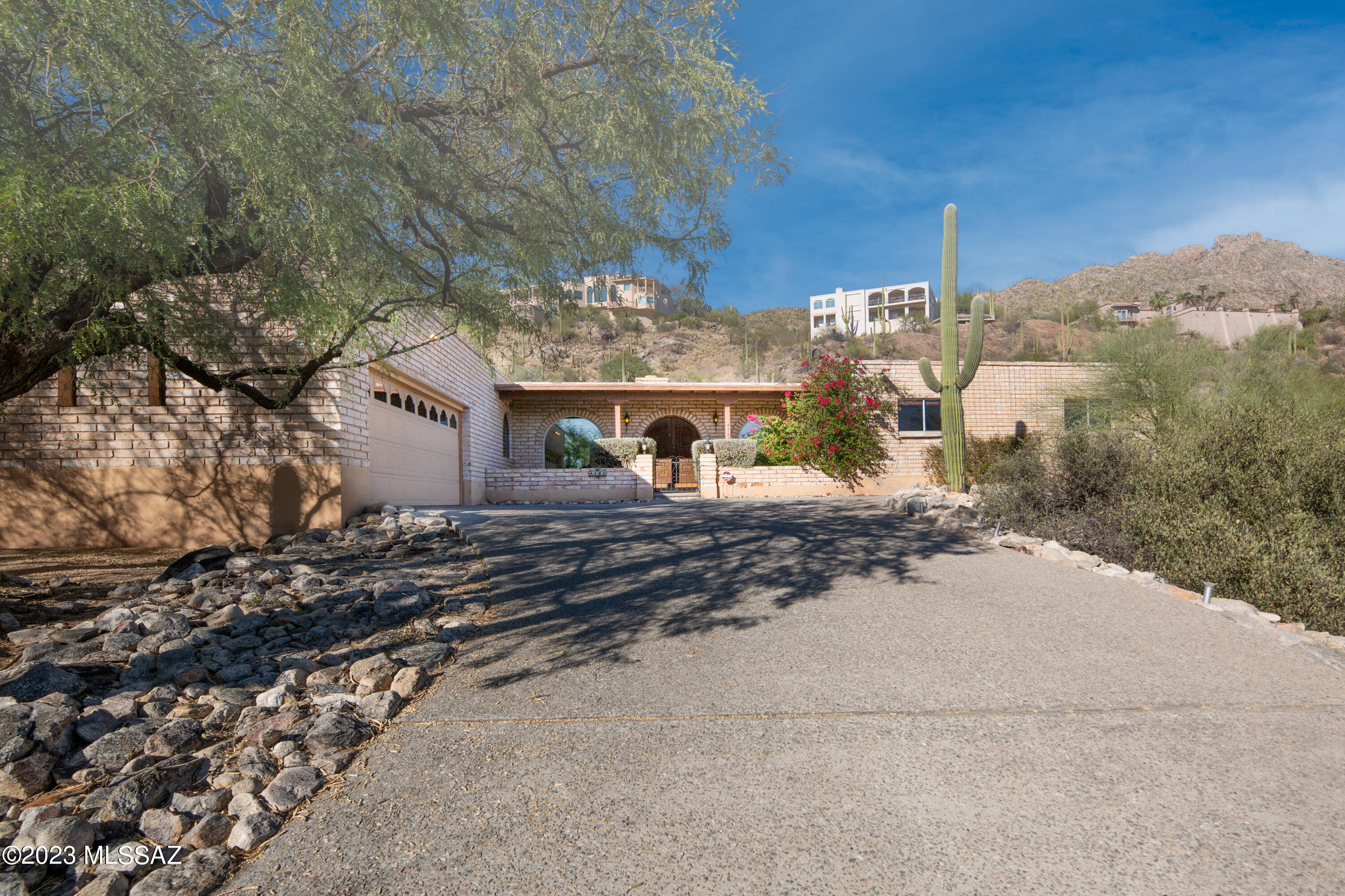 Welcome to 4163 E Coronado Dr, Tucson, AZ 85718. A charming single-family home nestled within the highly desirable Catalina Foothills. This territorial-style beauty, built in 1973, boasts 2256 Sq Ft and sits on a generous 0.74-acre lot., offering a superb balance between coziness and modern living. The home is bathed in natural light, thru every window in the house, highlighting its attractive layout. It comes complete with 3 spacious bedrooms, 2 full bathrooms, ensuring ample space for pleasure and relaxation. The primary bedroom boasts walk-in closet and offers breathtaking mountain views and a convenient office/den space. The kitchen is inviting with its radiant natural light, adjacent to the spacious family room with access to the covered back patio and the eloquent pool. Fireplace in living room add a touch of warmth and nostalgia to this lovely home.  The exterior features are as impressive as the interior ones, with a low-maintenance natural desert landscape on a low-traffic street, ideal for tranquil living. The home also features an extended paved driveway leading to a handy 2 car garage with ample storage space. Its location in the Catalina Foothills school district, proximity to parks, hospitals, and schools add up to an ideal place to call home. Come, be part of the thriving Catalina Foothills real estate market! This home isn't just a place to live but a lifestyle to embrace.