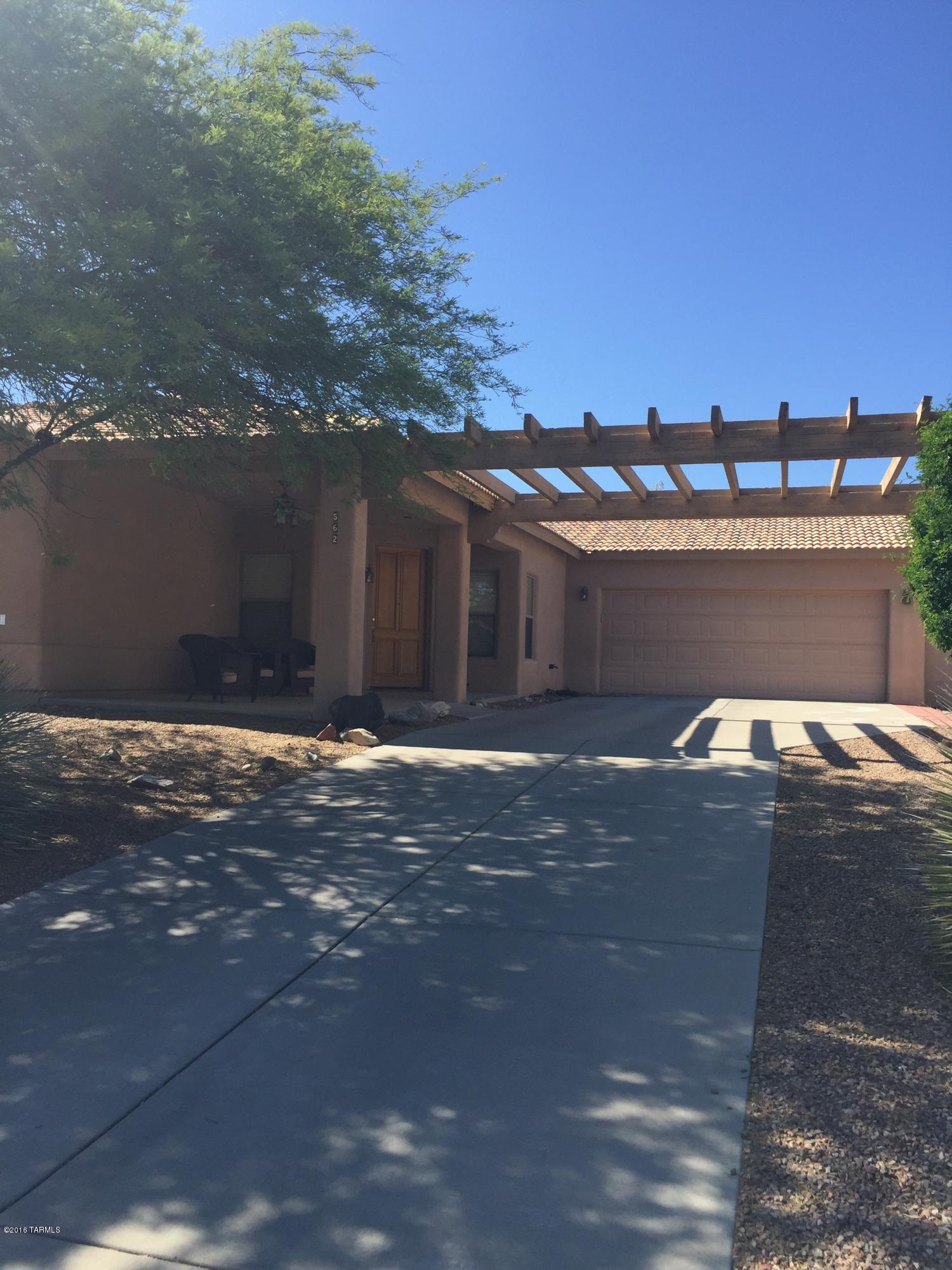 Almost 2000 Square feet of wonderful space in Rancho Vistoso. Steel frame and masonry stucco. Front covered patio area. Kitchen is open to great room and features corian countertops, Island and breakfast bar. Lots of counterspace. Speakers set in ceiling of family room and back porch.  Family room has beehive gas fireplace for cozy nights. Large master bedroom with dual his and hers walk in closets. 2nd and 3 rd bedroom open to Jack N Jill bathroom. Reverse Osmosis and water softener too. Garage is extended garage.  Plenty of parking space at this home. Backyard is big and has covered patio.  Separate fenced area could be great dog run. Dont miss out on this one. Call for a viewing today.