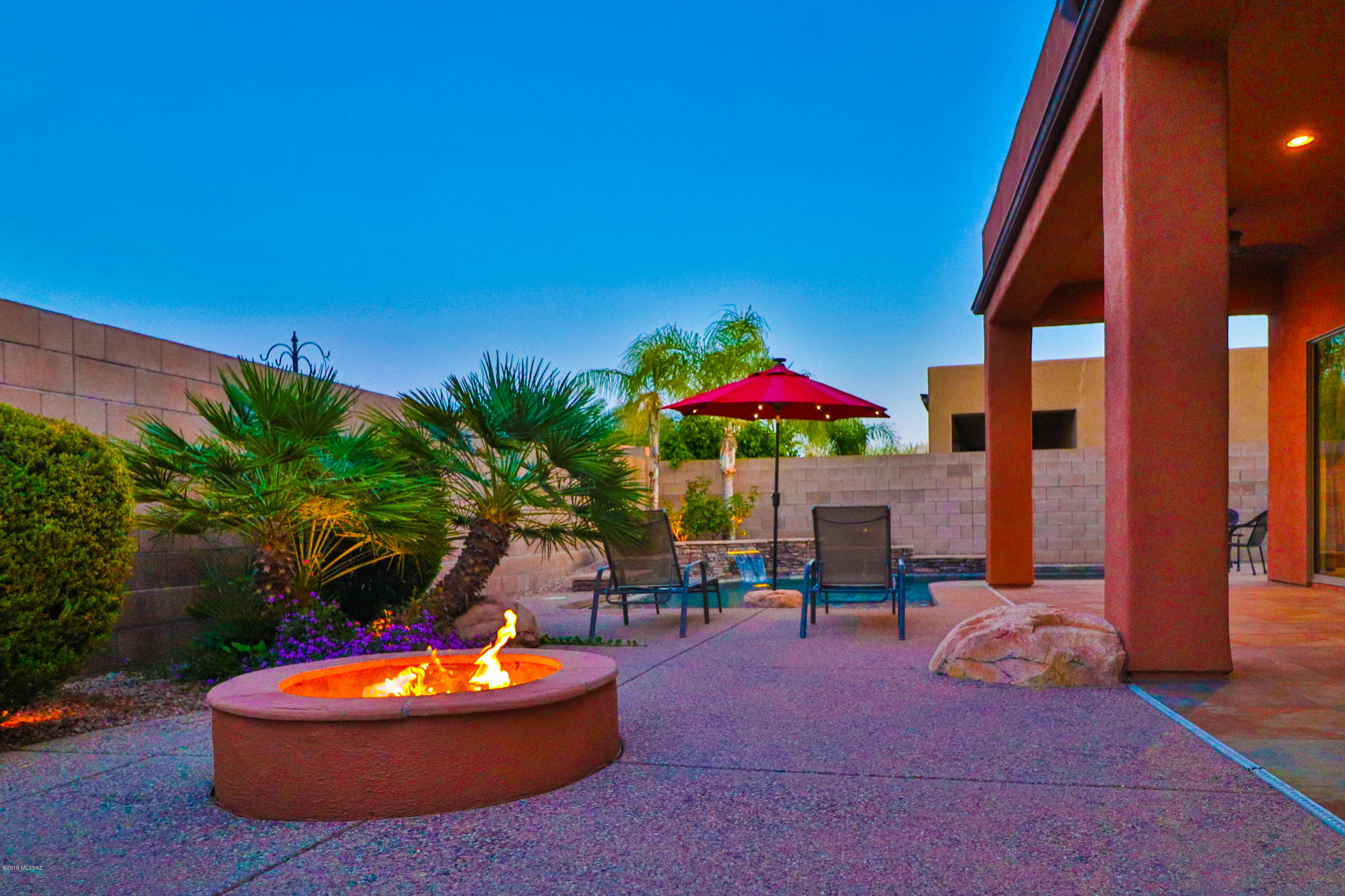 Stunning Santa Fe Style home in highly desirable Dove Mountain!  Entertainers dream!  2408 SF home features, 3 Beds + Den and 2 Baths!  Den currently features a home theatre.  Gorgeous eat-kitchen with granite center island, tiled backsplash, Stainless appliances and upgraded cabinets.  Big Formal dinning room off of entry for those family and friend gatherings.  After dinner take a dip in your refreshing pebble tech pool with water features and fiber optic lighting! Oasis like back yards also features built in BBQ and putting green!  Master bedroom has huge walk in shower and sliding glass doors that access the patio directly into the pool! Freshly painted inside and out!  3 car garage! Solar tubes installed for natural light!  Schedule your showing today!!!!!!!