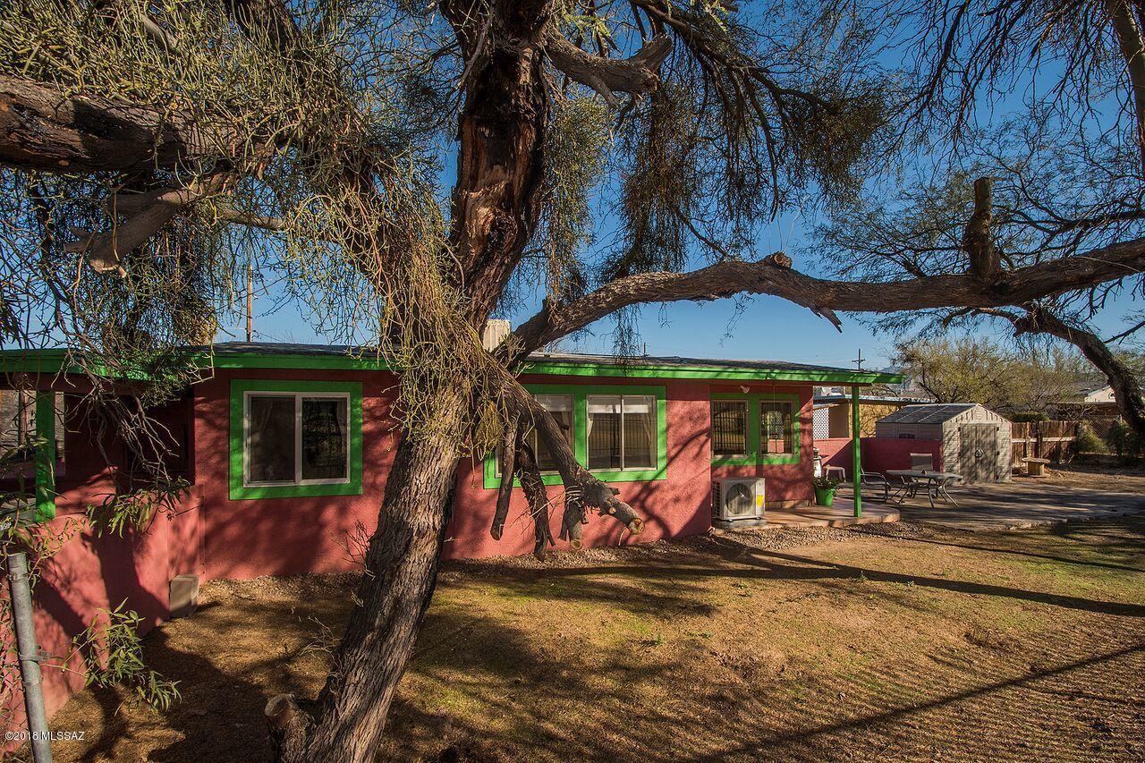 Great opportunity to own two homes on a beautiful over sized R2 lot near downtown, UA and Pima.  Main house is all tile and cute as a button with great views of El Rio Golf Course.  Tons of light and a very nice porch and patio area amidst a mesquite sanctuary, main is a 2 bed 1 bath. 
Guest House is also all tile and just as cute.  Perfect opportunity for guests or income, GH is a 1 bed 1 bath.  Hard to find lot this size and so secluded with established landscape.  Hurry on this one!