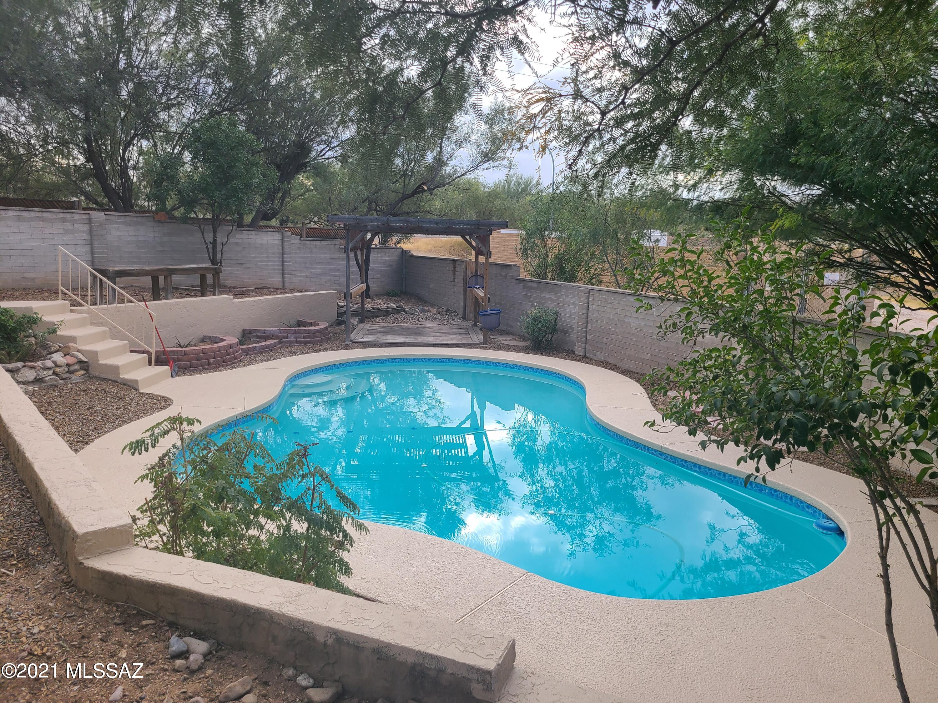 Enjoy the large, private pool & covered patio on the spacious 1/4 acre lot.There are shade trees, ramada & lovely vegetation. This beautiful 3 bdrm 2 bath has a bonus room off the master bedroom. NO HOA!!! Solar (owned) electricity. There is also a 20x20 bonus room/hobby room, home gym or office with its own separate entrance. The home has been totally renovated with new paint inside and out. Solar heating installed in 2018, solar for the pool installed in 2018, AC/heater installed in 2019. Tankless water heater installed in 2020, upgraded master bathroom. New roof in 2017. All wood-like flooring throughout, no carpet. Spacious, remodeled kitchen has new stainless steel appliances and all beautiful white cabinets, corian countertops, pullouts, and pantry. The new stainless steel frig. stays. Adajcent to this heart of the home is a great formal LR, dining room and large Family room with beautiful fireplace. Workshop with electricity in 2018.