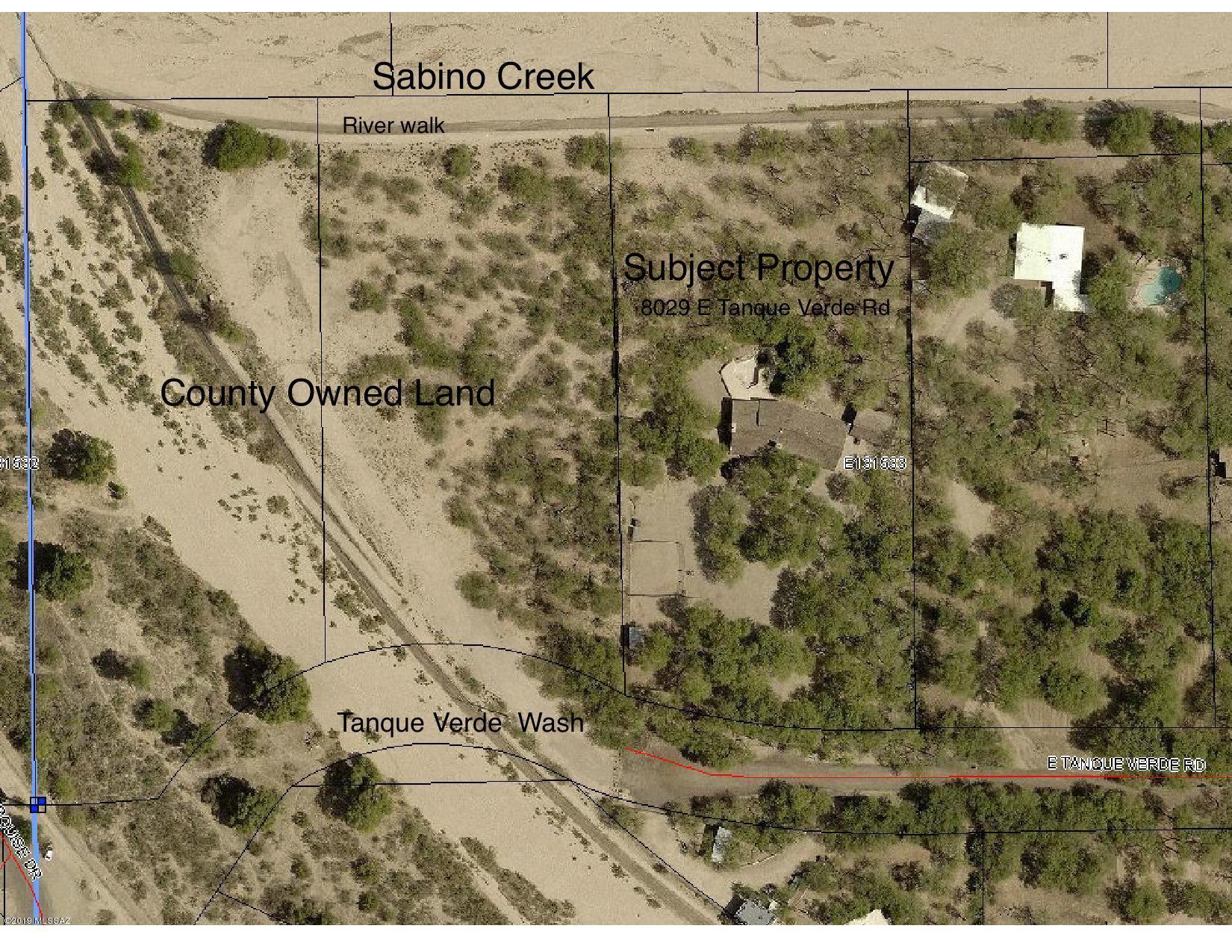 INCREDIBLE LOCATION, TREE LOVERS PARADISE! Old Ranch Charm! The value is the property and access to RIVERWALK and both SABINO CREEK FRONTAGE and TANQUE VERDE WASH! . POOL and ROOF need work ''as is''.  This is a forest of MATURE MESQUITE TREES.  No deed restrictions.PRIVATE WELL.  Pima County land to the West for added privacy.  TONS OF CHARACTER AND OLD RANCH CHARM.  INTERIOR FEATURES CONCRETE FLOORS, 3 FIREPLACES, GOURMET KITCHEN WITH CHERRY CABINETS AND GRANITE SLAB COUNTERS, STAINLESS STEEL APPLIANCES, WOOD PLANKED BEAMED CEILINGS, BIG LIVING AND FAMILY ROOM, UPDATED BATHROOMS, DOUBLE PANE WINDOWS.  Large attached carport and Large detached 2 car garage with workshop/storage room........MUST HAVE AN APPOINTMENT TO GO ON PROPERTY!