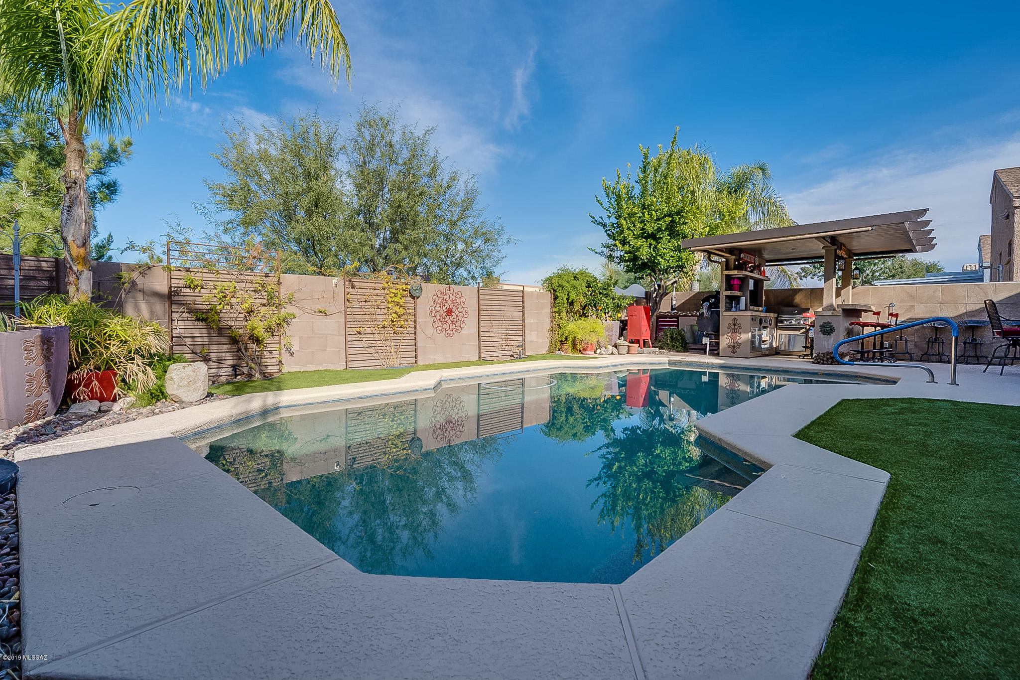Move in ready! Beautifully maintained and upgraded 3 bed/2 bath single story home with a den/office. The home features 2 amazing outdoor entertainment spaces, a lovely front courtyard and resort style backyard with solar heated pool, outdoor kitchen and mountain views. Open floor plan with upgraded tile throughout and high vaulted ceilings. Kitchen is remodeled with plenty of cabinet space, stainless steel appliances, gas stove, quartz counter tops and breakfast nook with bay window for natural light. Double doors lead you into a relaxing and spacious master bedroom. Master suite includes dual sinks, shower and walk-in closet. Has whole home water filtration system. Located in Vail school district with many top schools with walking distance. Close to shopping, TIA, Raytheon, and Davis-Monthan Air Force Base.