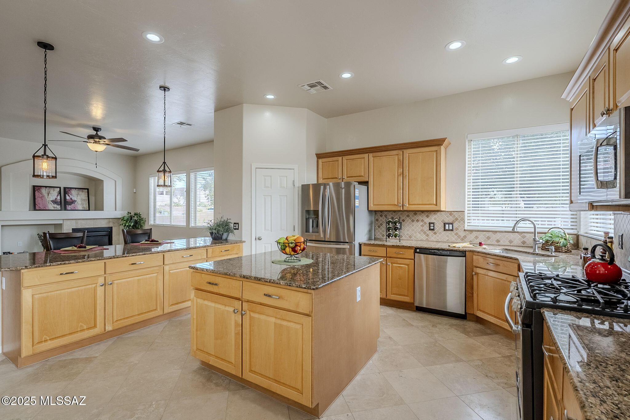 Discover your new Home in the sought-after gated community of Rancho Cancion! This stunning 3-bedroom, 2.5-bathroom residence with a versatile den has been tastefully upgraded. Step inside to find travertine tile throughout the main areas, complemented by new carpet in the bedrooms and living room. The freshly painted split floorplan offers privacy and functionality, ideal for modern living. The spacious kitchen boasts granite countertops, a breakfast bar, stainless steel appliances, and abundant cabinetry, making it a chef's delight. Relax by the fireplace in the living area or step outside to your private backyard oasis. Enjoy the sparkling pool with a new variable-speed pump, large flagstone patio, built-in BBQ, and artificial turf. Don't miss the  huge 3 car garage and storage shed