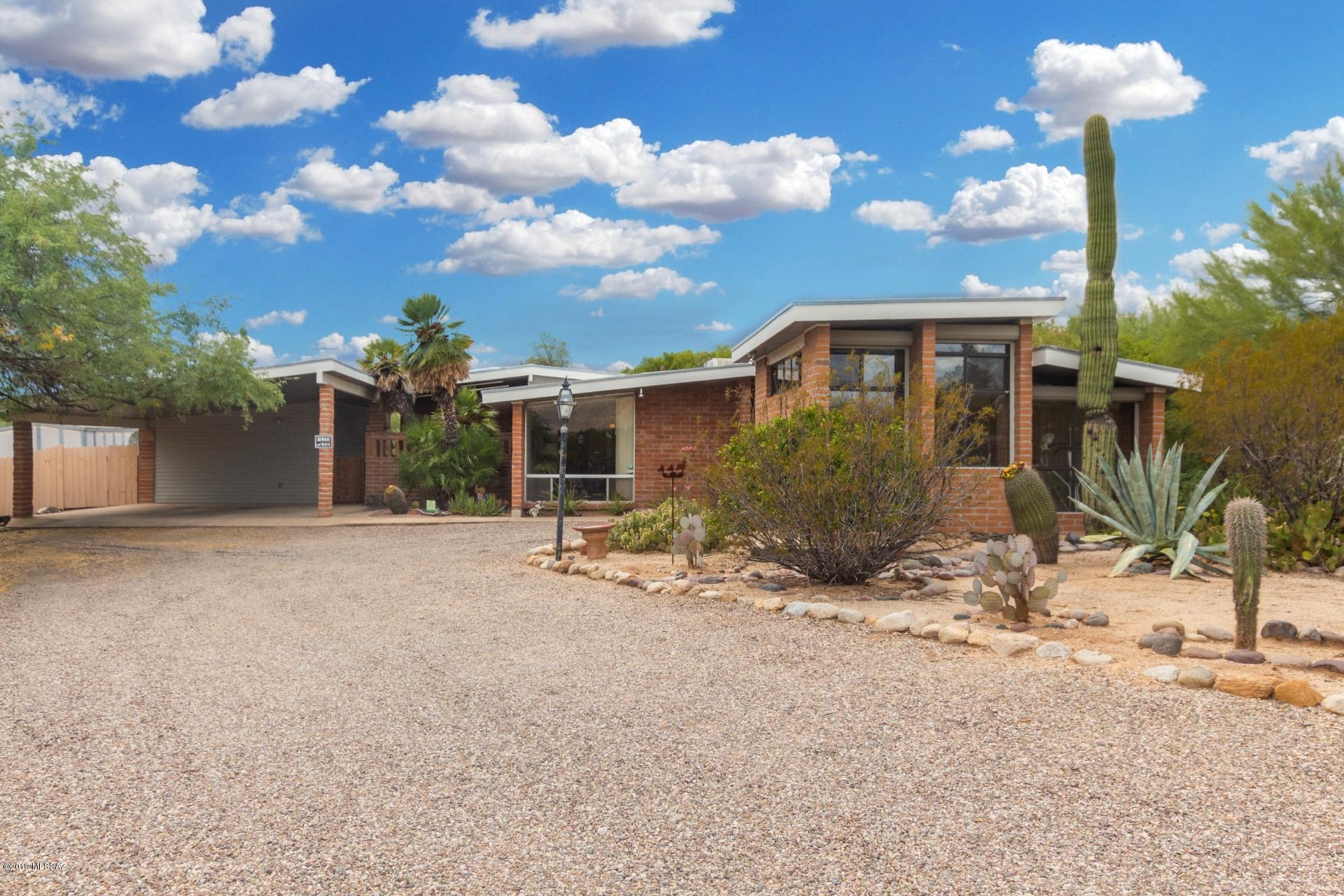 Lovely single-story 4 bedrooms 2 baths brick ranch style home located in Tucson. Enjoy low care landscaping in both front and backyards, front sunken living area, lots of large picture windows for lots of natural light, vaulted ceilings, den, fully enclosed Arizona room with exposed wood beams, dining area right off the kitchen, and laundry room with built-in storage cabinets. Kitchen features breakfast bar, white appliances, and lots of warm cabinetry for storage. Family room off the kitchen has wood-burning fireplace. Master retreat includes private ensuite. Expansive backyard allows exquisite mountain views, sparkling pool, and patio area.