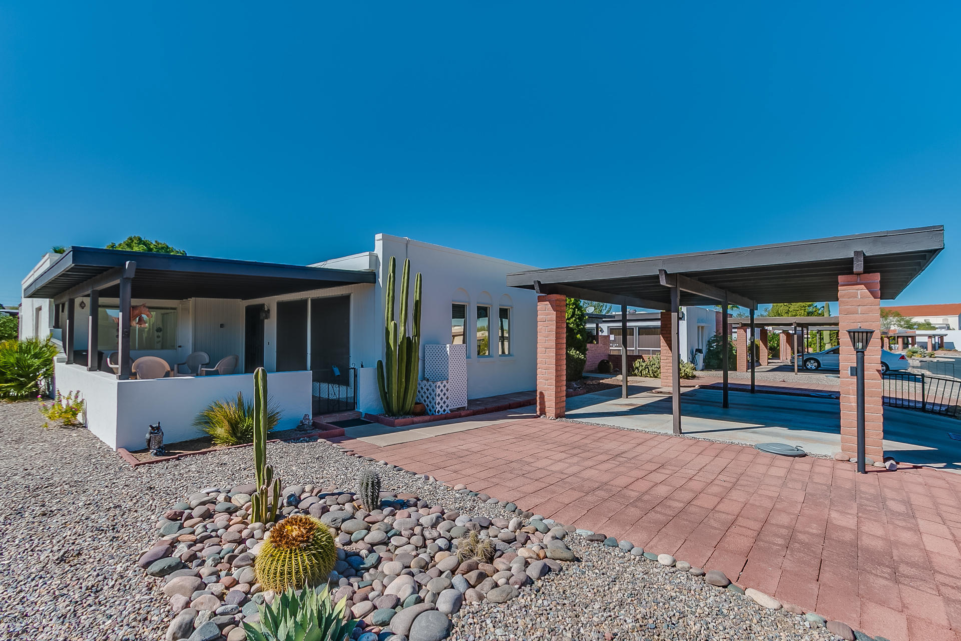 This very well cared for townhouse is 1316 sq. ft. with two bedrooms, two bathrooms and an attractive Arizona room addition and charming courtyard entry. You will love the updated kitchen with warm maple tone cabinetry and crisp white appliances. Both bathrooms have also been updated with pleasing neutral finishes. The living room is spacious with a view of the neighborhood and Santa Rita Mountains in the distance. Don't miss the opportunity to own this little desert gem with manageable back yard and no rear neighbor.