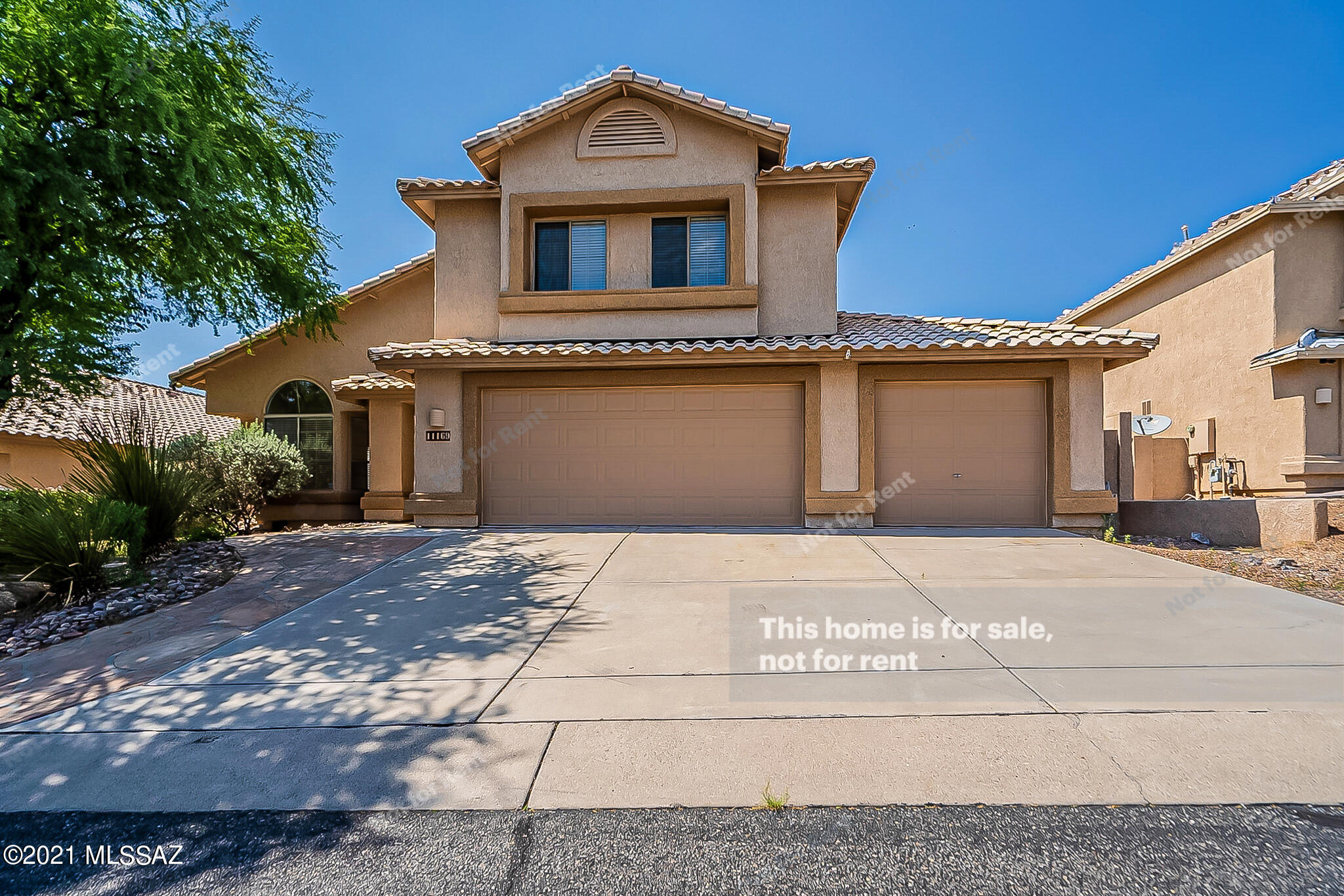 This Tucson two-story home offers an in-ground pool, a patio, and a three-car garage.