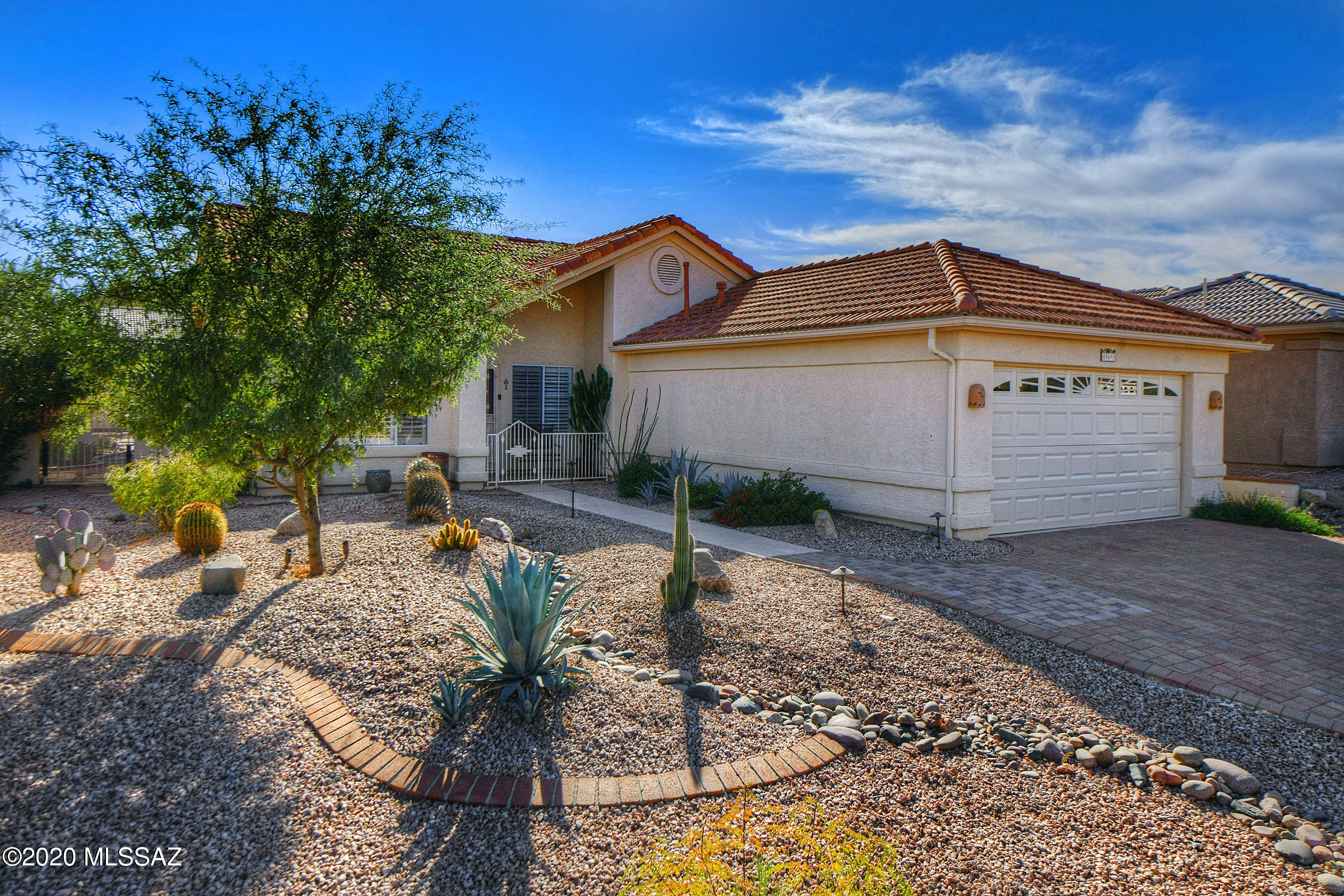 Gorgeous 3BD/2BA (1,909 sq ft) extended Diego plan boasts vaulted ceilings, upgraded flooring and countertops, lush landscaping plus striking Catalina views. Gated entry flows to a formal living/dining room. Beyond lies a Great room w/ fireplace for modern living. Chef's kitchen hosts quartz countertops, stainless appliances, breakfast bar, dining nook w/ bay window and French doors to rear patio. Lovely Master suite hosts a tiled walk-in shower, walk-in closet and patio access. Full hall bath plus extended laundry/hobby room. Extended garage has built-in cabinets & utility sink. Fabulous rear yard boasts an extended patio, solar heated pool, fire pit and views! SaddleBrooke is Tucson's Premier Active Adult Community offering Clubs, Pools, Golf, Tennis, Pickleball & Performing Arts Center.