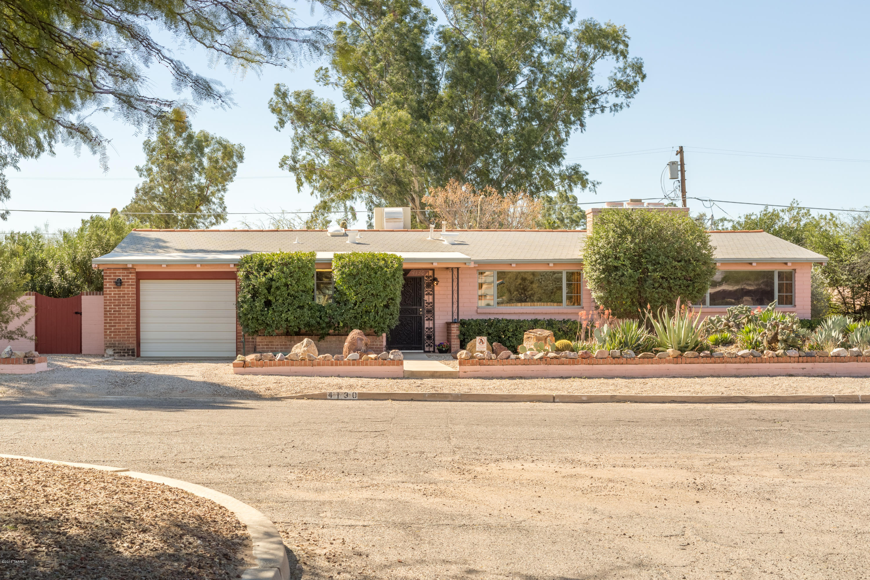 Looking for a home with 1940's character and charm? This is it!  This 2 BR plus office has huge greatroom with large window views of the Catalinas. Plank ceilings, and wood cabinetry built-ins throughout. Wood doors enclose an abundant amount of storage in every room. A rare find to have 1/3 acre in town with 2 porches and lots of room to create outdoor living spaces. Don't miss the large laundry room in back with more cabinets and even pullout shelves for folding clothes! Workshop is at the end of the 1 car garage.  Only 2.7 miles from the U of A!