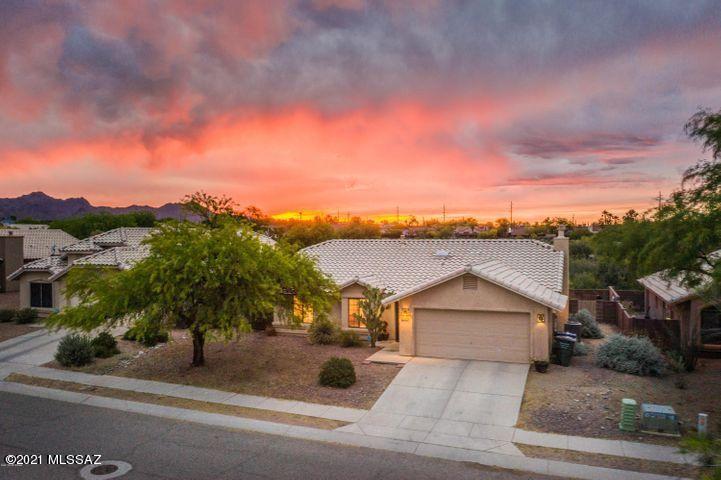 OPEN HOUSE SAT 2/6, 1-3PM. MOVE-IN ready in a sought after west side neighborhood WITH VIEWS won't last! Newer HVAC and hot water  heater and includes ALL APPLIANCES as an added bonus. This 3 bed, 2 bath home won't disappoint. Large lot with gorgeous sunset views and no neighbors behind. Open floorplan with high ceilings boasts a great room with stacked stone fireplace, and a large dining nook and upgraded kitchen with granite countertops. Neutral tile throughout with newer carpet in bedrooms. NO HOA! Close to UA, Pima, I-10 and more. Get ready to own a dream come true!