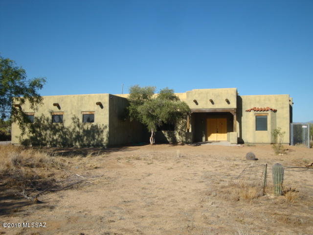 Santa Fe style custom Home in Diamond Bell Ranch with amazing views of Kitt Peak and the Sonoran Desert. Underground Utilities with Tucson City water, Trico Electric and Southwest Natural Gas. No HOA. Over sized 3 car garage  and separate huge detached 2 car garage,/workshop. Fully fenced backyard. Great room, skylights, kitchen with custom Mesquite cabinets and soft water loop. New Carpeting.
 A quiet and serene rural environment for you to enjoy.
Come and see!