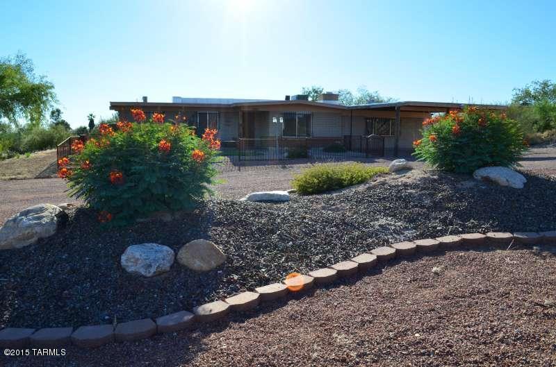 Updated ranch home on over 3/4 of an acre is perfect for entertaining. Huge island kitchen w/ tons of cabinet space, stainless steel appliances & custom designer mural. This versatile home has a separate family room (currently a game room), large 4th bedroom/bonus room, and RV pad w/ hookups. Stacked stone fireplace in living room. Backyard oasis w/ NEW kool deck, extended covered patio, swimming pool, spa, dog run, and basketball court. Lots of custom wrought iron, natural desert surrounding and mountain views, plus new water heater and all appliances included.