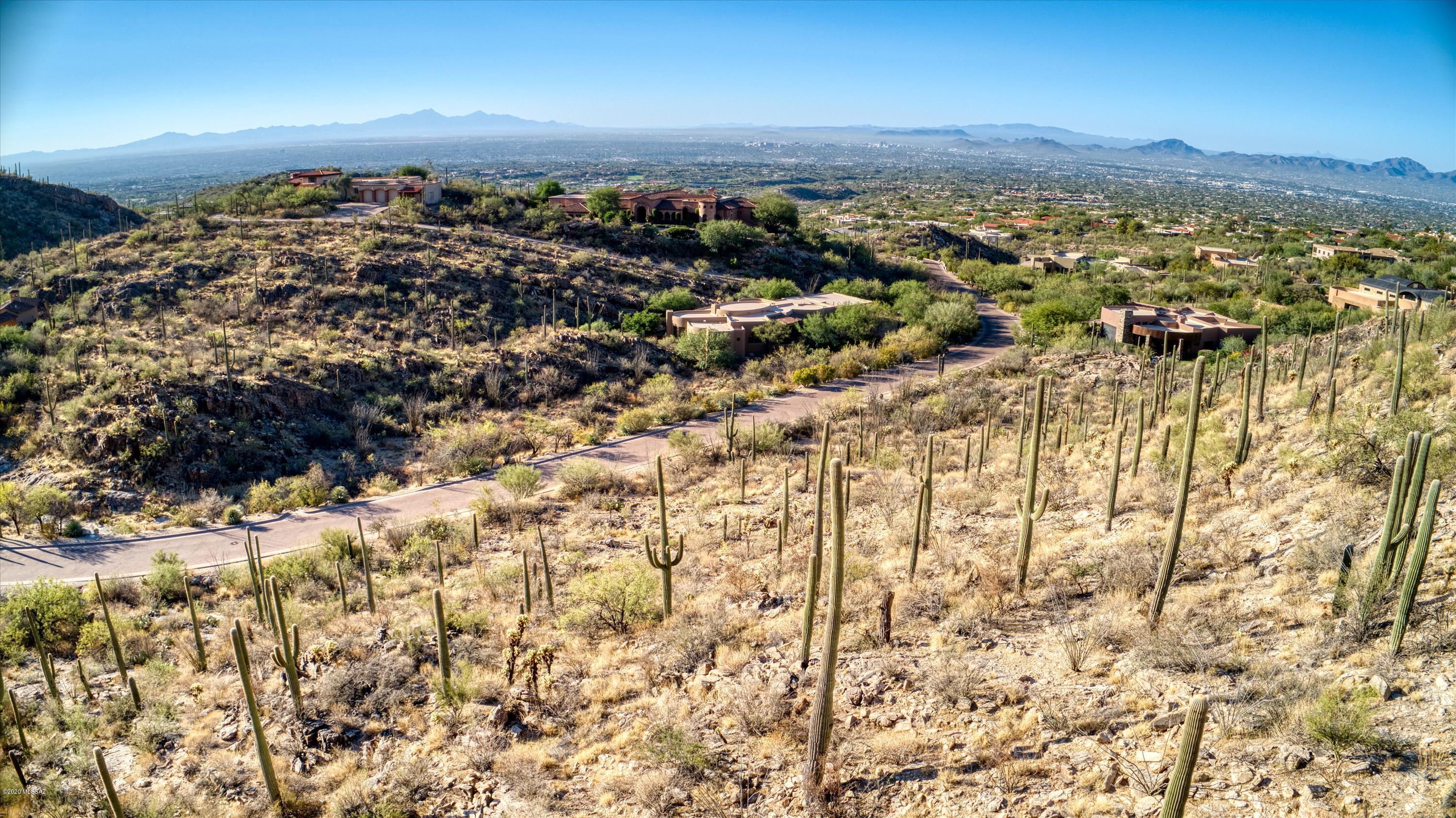 Stunning 3.3 acre pristine homesite backing up to the Coronado National Forest in the heart of Tucson's Catalina Foothills located in The Canyons. Arguably Tucson's most exclusive guard gated community. Immerse yourself in the tranquility and quiet of the high Sonoran Desert with breathtaking sunrises, unbelievably beautiful sunsets, clear starry nights, an abundance of wildlife and great variety and density of vegetation.

Click on PHOTOS for Aerial photos and aerial video