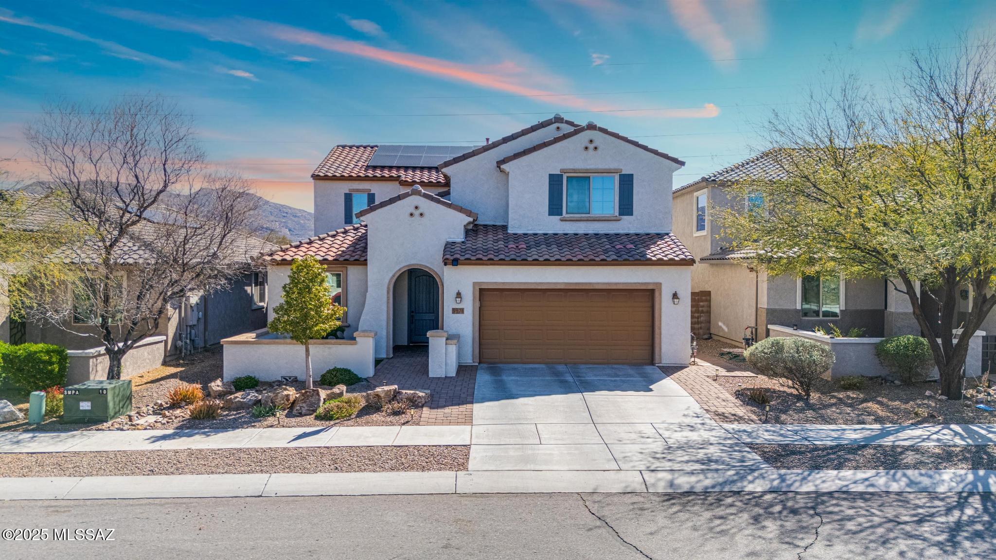 Looking for a highly upgraded oasis?  Then this may be your home.  Pulling up to the home you will immediately notice the cul-de-sac location and courtyard entrance.  Upon entry you will enjoy the gourmet kitchen with double roll-out in all lower cabinets, walk-in pantry, 18+ foot tall family room ceilings, as well as upgraded bathrooms, laundry, large walk-in shower, 8' interior doors downstairs, interior lighting, flooring, and window coverings.  The openness of the backyard will quickly invite you to enjoy the view fencing, salt water pool, spa or simply the covered patio.  This home offers 3 bedrooms / 2 bathrooms upstairs (With one bedroom / bathroom as an en-suite).  Additional upgrades include tankless water heater, water softener, 220amp car charger garage outlet, and owned solar! Beyond the home, Sierra Morado offers multiple play parks, dog park, community pool, basketball courts, sand volleyball, and close proximity to the highly rated Senita Valley elementary / Rincon Vista middle Vail Schools / New TMC Hospital.