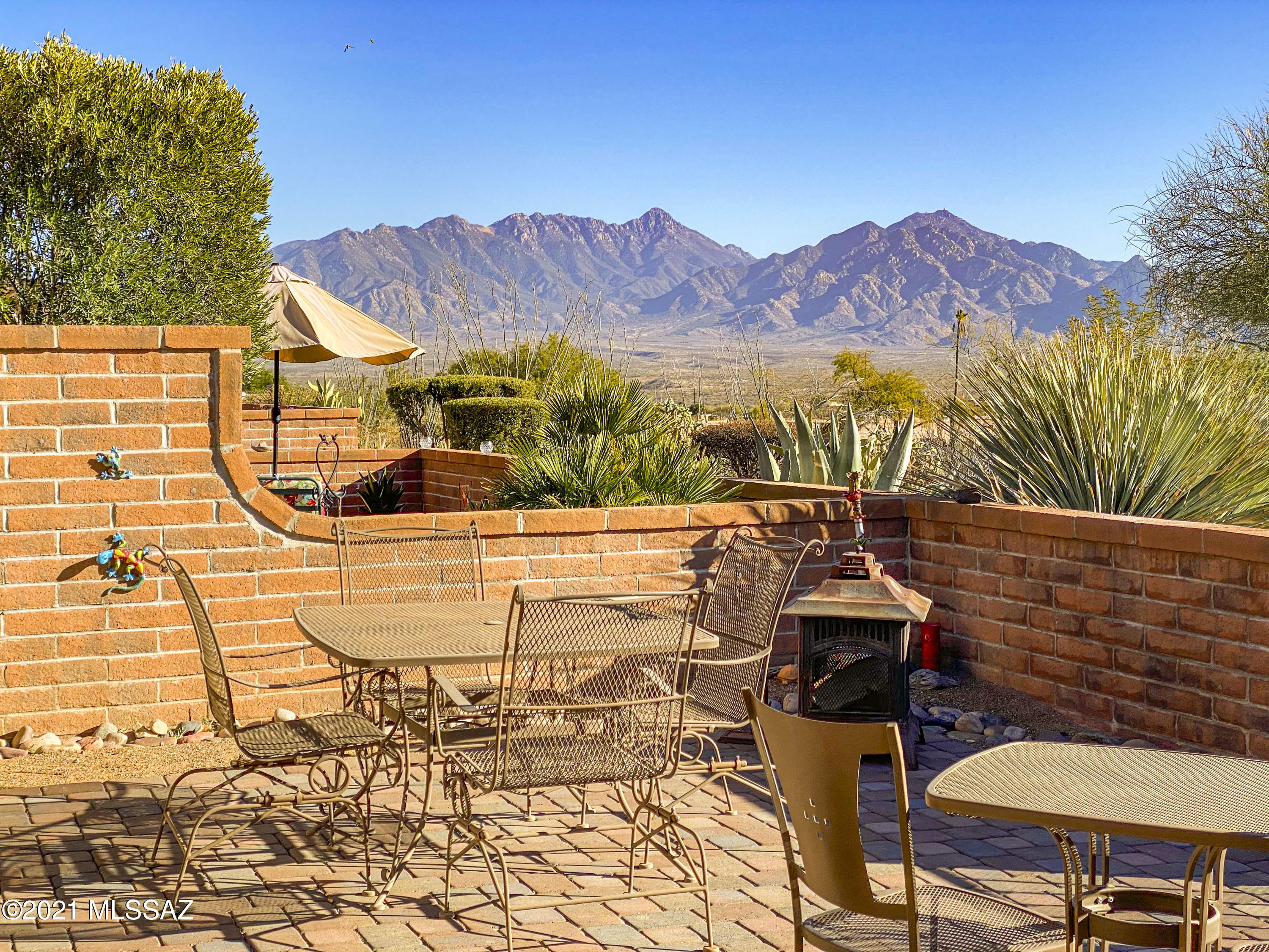 It is all about the VIEW!!!   Easy care slump block construction will keep maintenance costs in checks too.  You'll immediately notice two skylights providing natural light into the open dining room and living areas.  The kitchen has generous cabinetry, pantry closet and room for a small table for casual dining.  The large master bedroom has patio doors that lead to the Arizona room.    The guest bedroom has a cleverly hidden murphy bed that fold out of the close so the room can be used for hobbies, crafts or even an exercise room when you need it.  Step out to the patio where this private setting delivers easy access to the Canoa Hills Recreation Center and miles of walking trails at Canoa Hills Trails!  A great patio with unobstructed views of the Santa Rita Mountains will surely be wher where you watch the sunrise or sunset -   maybe even both!