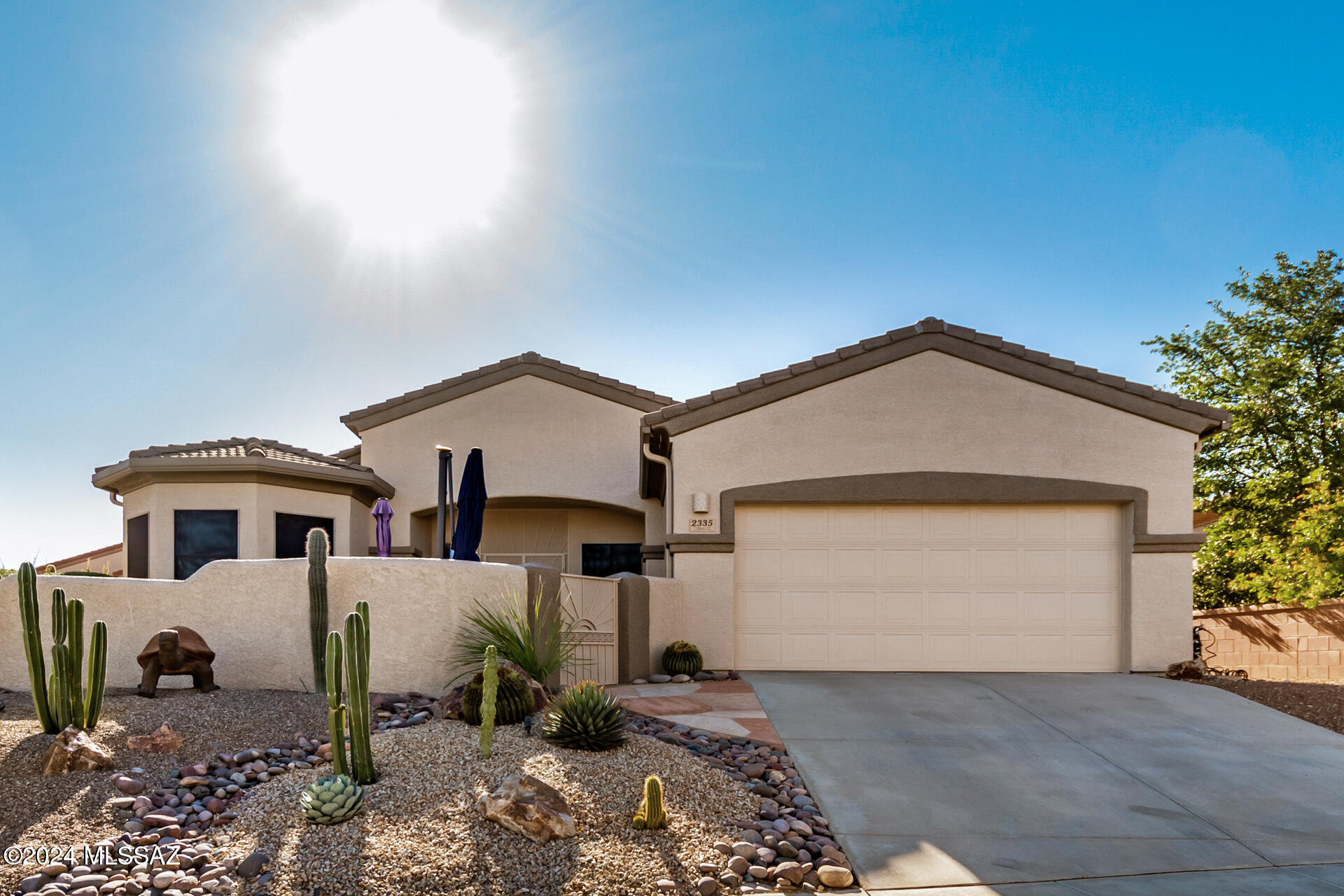 Discover this charming 2-bedroom home in Green Valley, boasting fantastic curb appeal with a 2-car garage and stunning desert landscaping. Enjoy an inviting patio with breathtaking mountain views. Step inside to find a spacious great room with high ceilings, a cozy palette, and a fireplace for warm gatherings. The gourmet kitchen features ample wood cabinetry, pendant lighting, stainless steel appliances, a pantry, and a unique two-tier island with a breakfast bar. A versatile den makes for a perfect office. The main bedroom offers a sitting nook, en suite bath with double sinks, and a walk-in closet. Relax in the backyard with a covered patio and pavers. Located in a gated community with a golf course, clubhouse, and more!