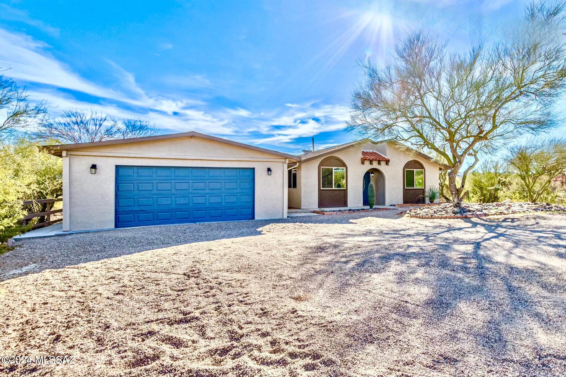 Truly exceptional home in West Tucson! This impeccable home features 3beds-2baths & a 1bed-1bth guest house! This is perfect for accommodating guests, in-laws, or even serving as a private home office. Walk into the main house offering a spacious living room with a wood burning fireplace. The dinning room area is open to the rest of the house perfect for entertaining. With tons of natural light the immaculate kitchen features white cabinetry, GRANITE countertops, & new SS appliances. The home has all new texture, paint, carpet, wood-looking floors, light fixtures & more! Relax in your owners ensuite with private newly reconfigured bathroom featuring a designer tiled shower, plenty of closet space as it has 3!! This spacious West side home sits on 1.0+ acres with ample room inside and out!