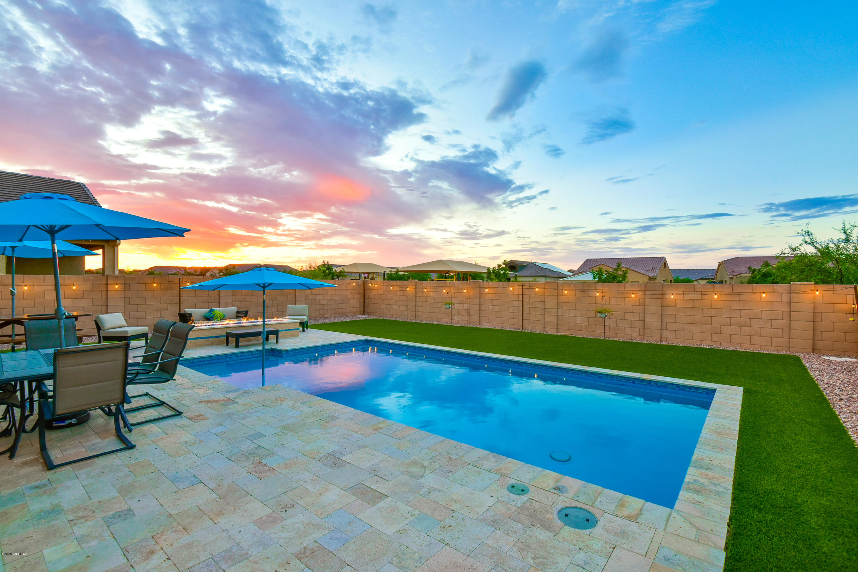 Discover style and function in this elegant Saguaro Bloom home! Pueblo floorplan opens to a great room with soaring ceilings, off-set tile, a neutral color palette & formal dining area. Island kitchen with granite counters, upgraded cabinetry, custom backsplash, stainless steel appliances, & walk in pantry. 2nd story is complete with cozy loft, 2 generously sized guest bedrooms, and a full bath with dual vanity. Master Suite features bathroom with large walk in closet, separate soaking tub, walk in shower, and dual vanity. 4th bedroom & powder room are located downstairs. Step out to the backyard for exceptional sunset views, gather around the fireplace with friends and family, or cool off in the newly built pool. EV charging station, Ring security system & financed solar panels.