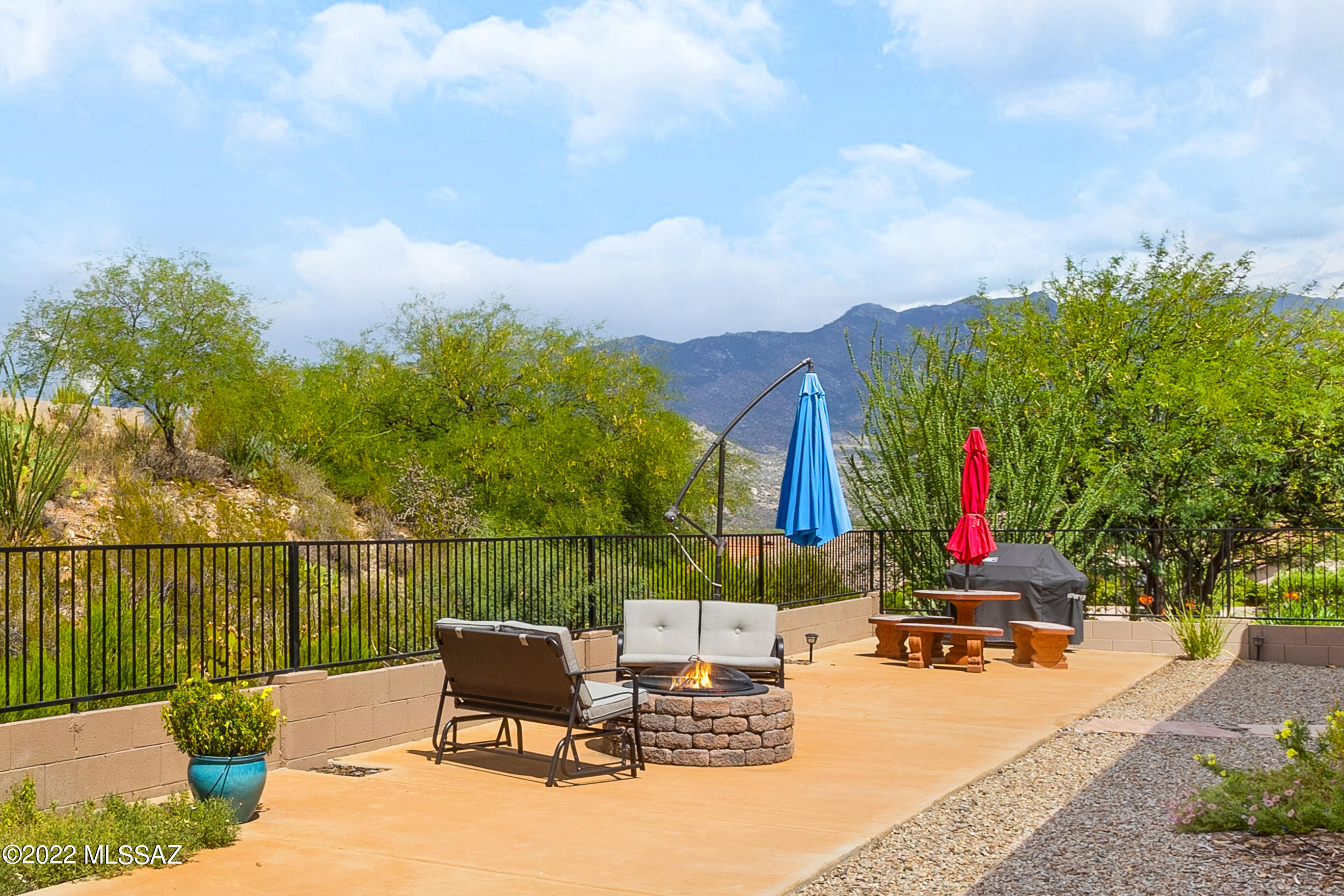 Beautiful Cimarron with Mountain Views. This 2 Bedroom + Den / 2 Bathroom / 2,296 SF /  Extended 2 Car Garage home is just the place to call home. Gated Courtyard designed with pavers to enhance the lovely flower gardens. No carpet thru-out. Great room features double tray ceilings & built-in entertainment center with gas fireplace. Updated Kitchen has Stainless Steel Appliances, Quartz Countertops with tile backsplash & kitchen dining area. Owner's Suite with slider. Remodeled Owner's Bathroom has Quartz Countertops, tiled walk-in shower & closet. Laundry room with storage. Extended 2 Car Garage. Gutters added & home painted in 2019. Arizona room has windows with screens for entertaining. Lovely Landscaping & Gated Yard. Enjoy your backyard with green space, fire pit, & mountain views.