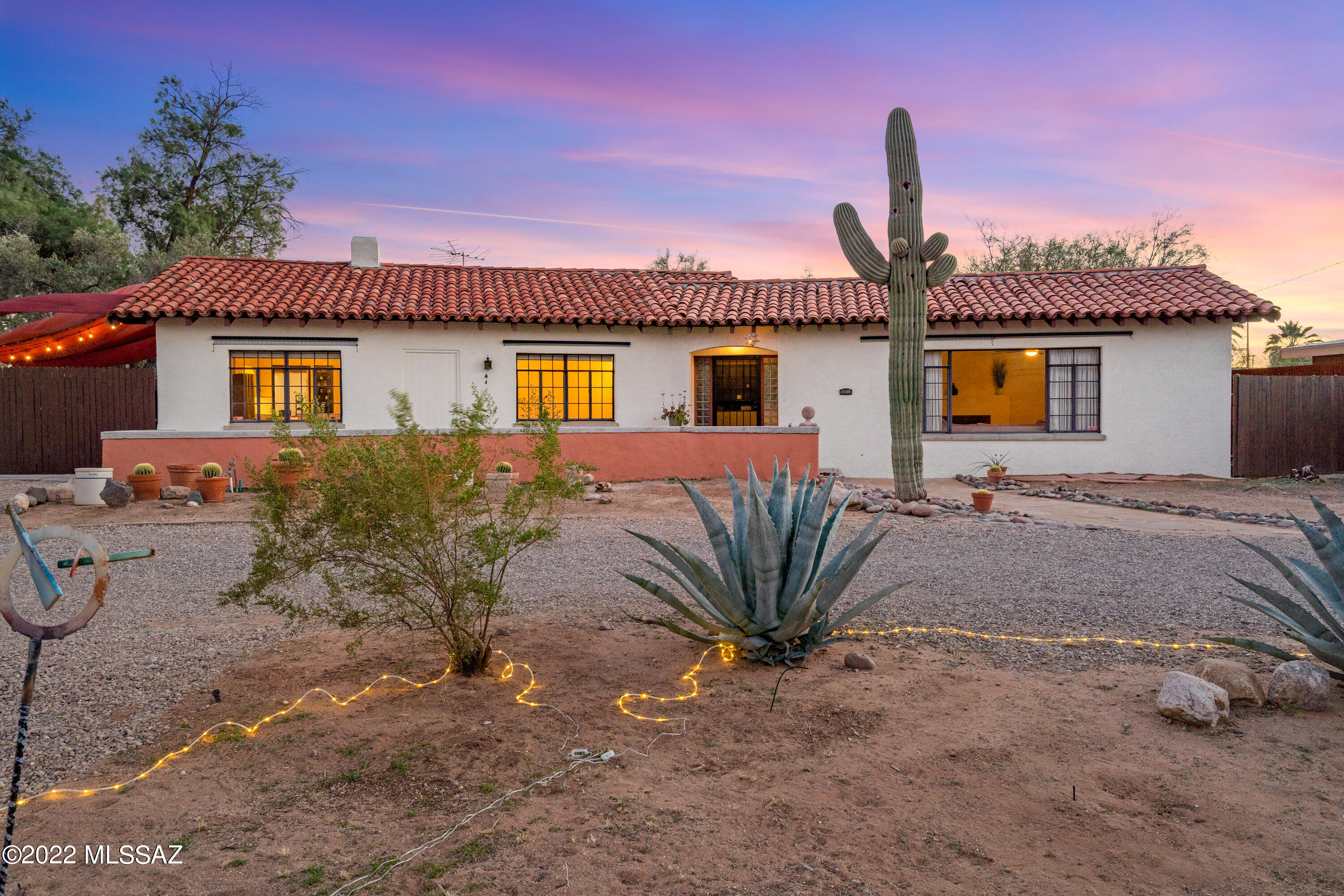 Wonderful 1934 home on a large .57 acre lot in the center of town! This beautiful gem has original details including coved ceilings, hardwood floors, stained glass, art deco bathrooms, colorful ceramic tiles and stylish vintage kitchen. Absolute privacy and security with recently added metal fence & electric gate. Beautiful views of the Catalina Mountains and plenty of room for all your toys; bring your motor home, boat, extra cars, add a vegetable garden, pool or casita! This property has grandfathered water rights, cedar closet, refinished basement, circular driveway and a hot tub under the stars! Easy access to the AZ Inn, U of A, downtown and the recently developed Grant Rd. corridor filled with lively dining and shopping. Don't miss this rare opportunity to own a vintage treasure