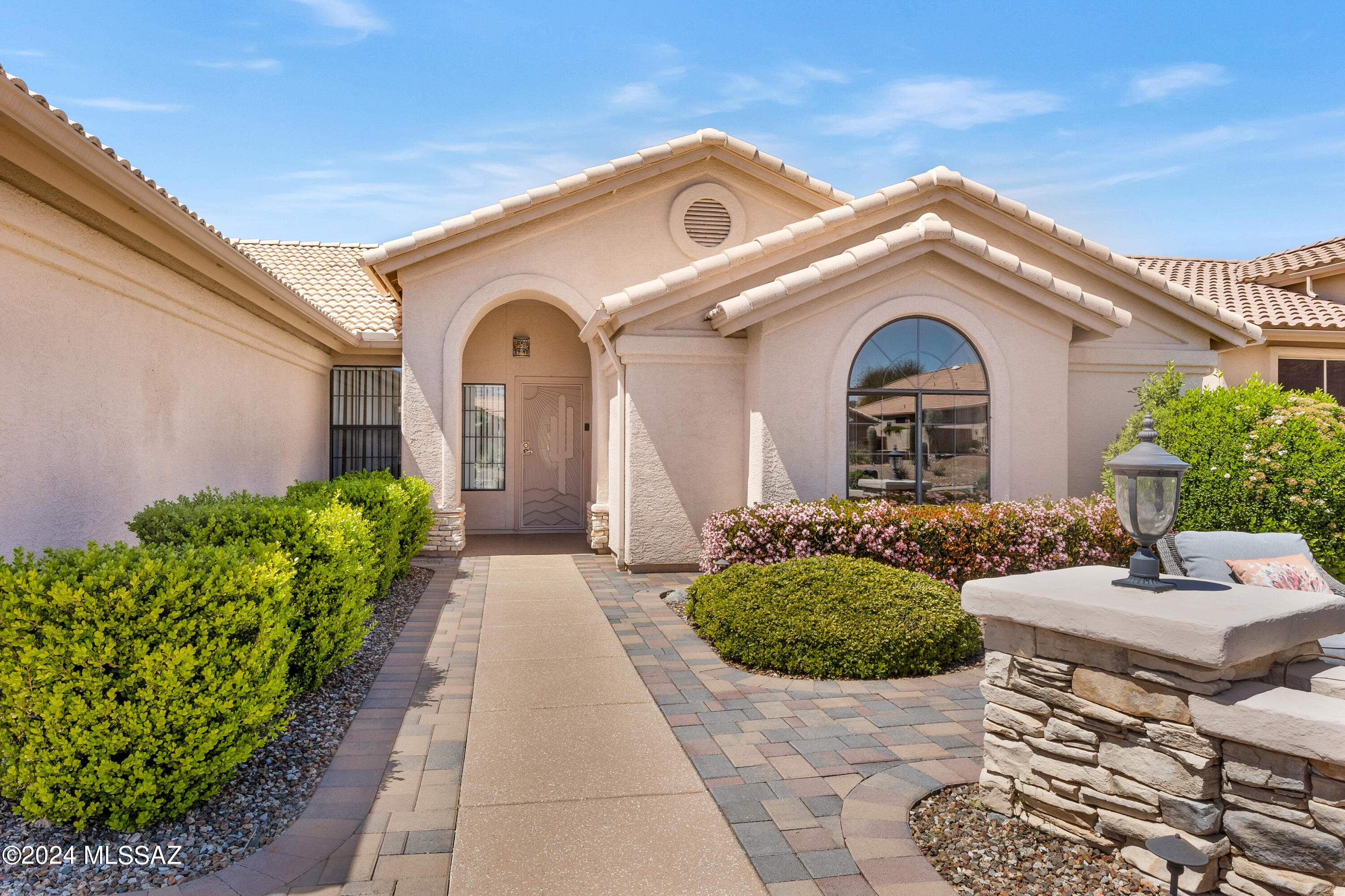 Sited high above the golf course on a quiet street, this 3BR Topaz offers views of the mountains from both front & back. Excellent curb appeal with clean, epoxied driveway & front walkway + paver courtyard that's perfect for enjoying morning coffee & breathtaking sunrises. Views of the verdant double fairway and hillside beyond beckon from the front door. Bright and spacious, this well-kept single-owner property has freshly painted walls, neutral décor + brand-new carpet in living room & bedrooms. Crisp white kitchen has stunning Black Galaxy granite tops and newer SS appliances w/gas range. Entertaining space extends outdoors from 3 sliders to expansive and elegant pavered patio with extended pergola shading and raised seating area. Spacious owners suite with views and slider for private patio access. Executive height countertops with exquisite granite tops and custom tiled showers are features of both bathrooms.  Unexpected extra storage at the reinforced garage attic, accessible via pull-down ladder, and above the BR 3 closet.  Move-in ready w/prelisting inspection of roof and 2017 Trane 14SEER HVAC.