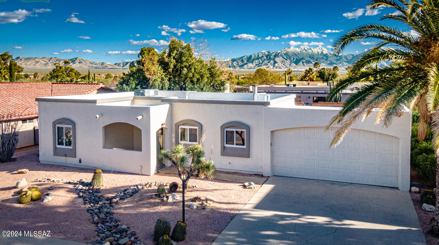 From the moment you arrive you'll feel right at home in this super cozy 2 bedroom, 2 bath, with AZ room and 2 car garage single family home with mountain views! Plus, it's located in the heart of Green Valley! 
Step inside & enjoy the cozy family room with FP & included TV! the AZ room features its own TV, heating/cooling & also provides easy access to the back yard with doors on either side.  Entertain outdoors at the bar area where the Ramada gives you just enough shade on the south side; or the tree provides needed shade on the north patio! Plus, there's room for cornhole or horseshoes if desired! There are 3 TV's included too!  Large laundry room w/storage; eat in kitchen; breakfast bar; guest room & plenty of closet space. Newer HVAC, windows, front door & very well maintained.