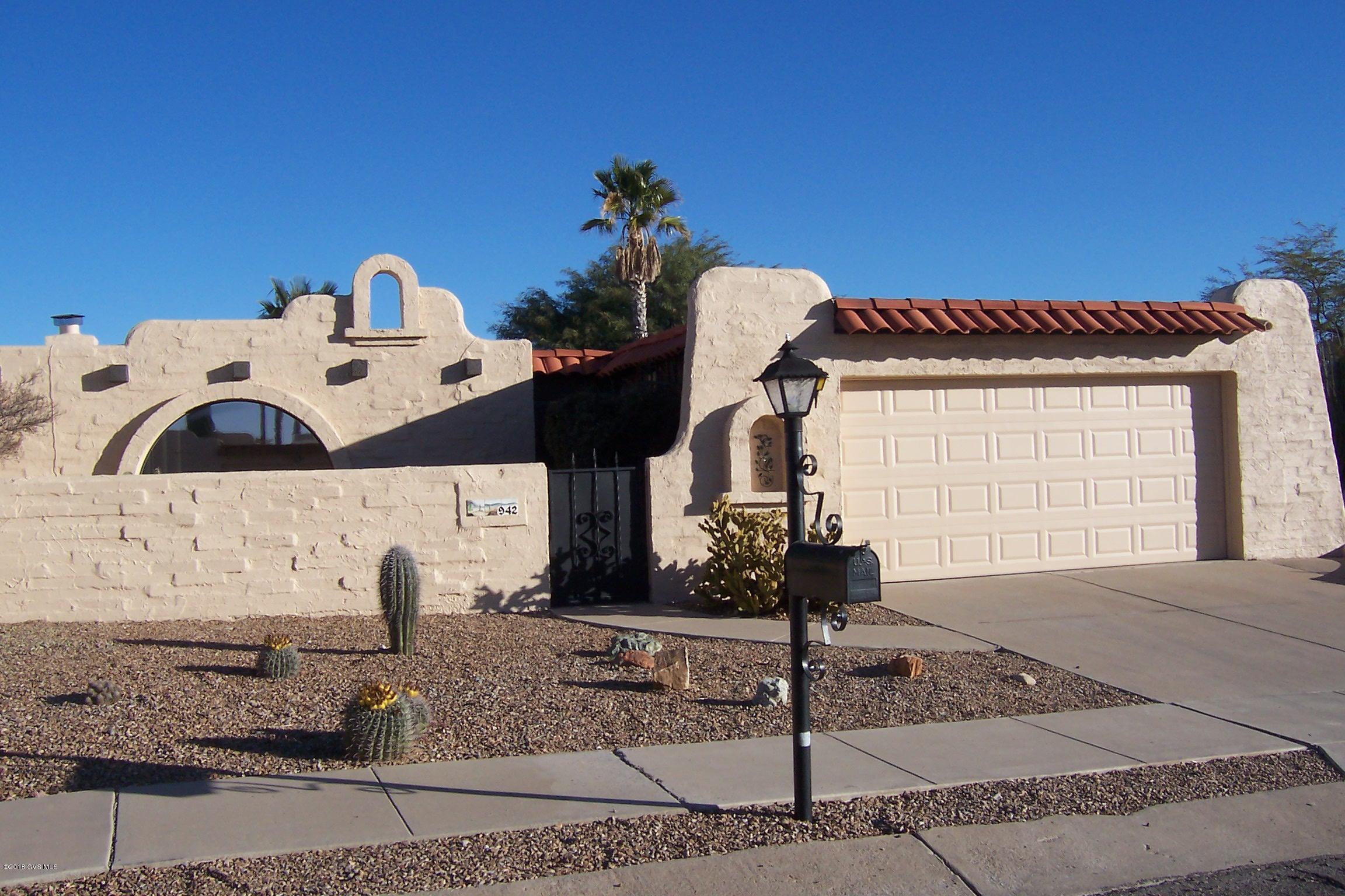 Lovely, bright, Spanish Mission style end unit TH w/2 bedrooms, 2 baths, 2 car garage. Private front & backyards. Freshly painted inside and out (1/2018). All tile except for carpet in bedrooms. Updated kitchen w/travertine tile counters makes it a pleasure to cook. Kitchen open to dining and living areas for easy entertaining. Both baths are clean and sparkly with reglazed tubs and tub surrounds, refaced cabinets (1/2018) and newer faucets and light fixtures. Guest bath also has a new commode. Nice sized bedrooms and master bedroom walk-in closet has a convenient floor safe. Laundry room has utility sink. More living space in the large screened Arizona room. Water heater replaced 2017, roof recoated 2017. Close to the neighborhood rec center with pool, hot tub & tennis/pickleball courts.